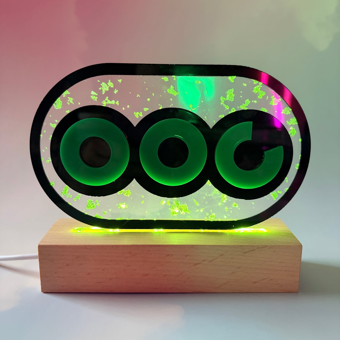 Handmade stamina wheel LED lamp with a hand-poured resin panel, silver leaf accents, laser-cut green acrylic design, and customizable RGB lighting.