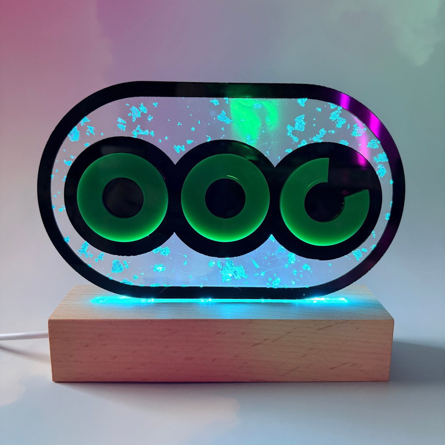 Handmade stamina wheel LED lamp with a hand-poured resin panel, silver leaf accents, laser-cut green acrylic design, and customizable RGB lighting.