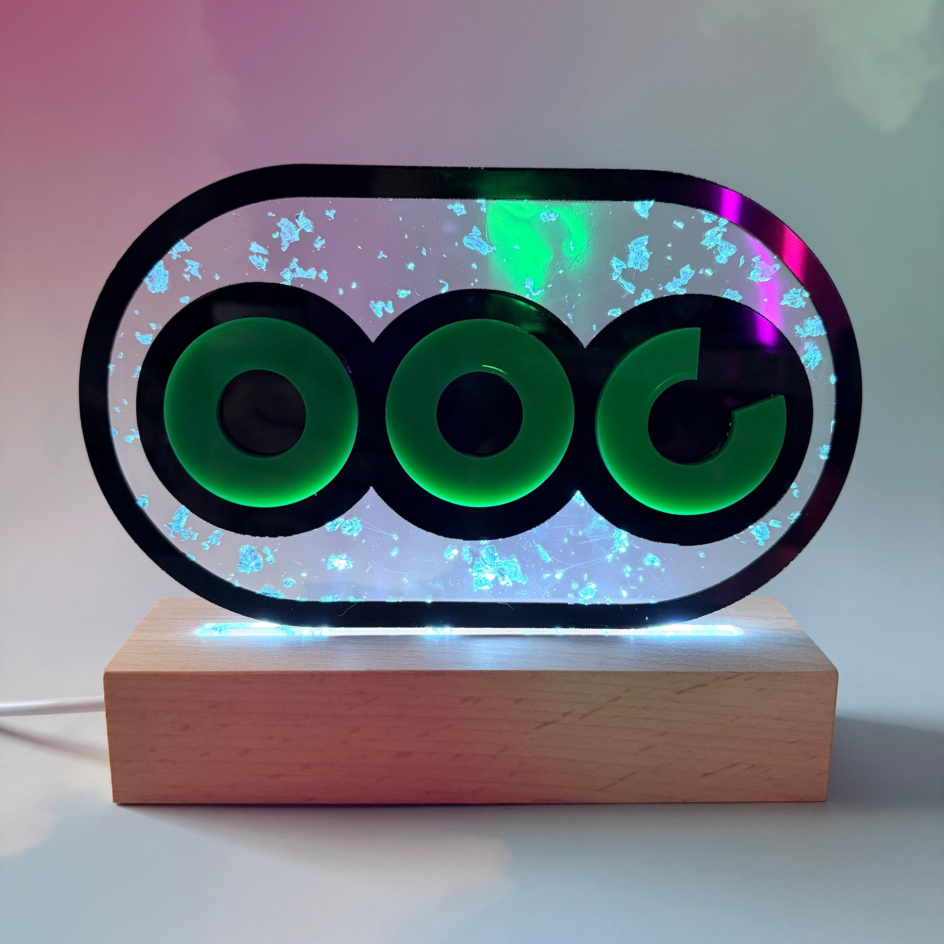 Handmade stamina wheel LED lamp with a hand-poured resin panel, silver leaf accents, laser-cut green acrylic design, and customizable RGB lighting.