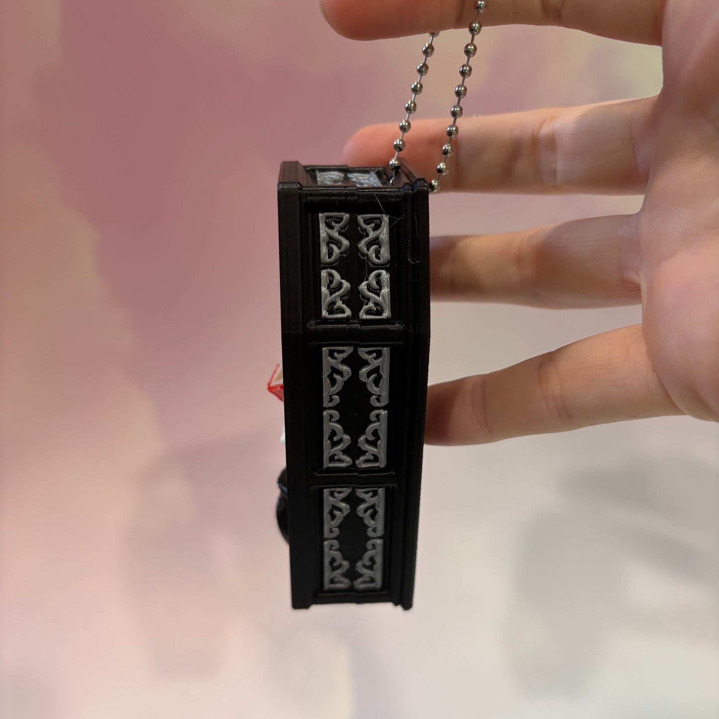 Mini 3D printed black coffin shelf fidget clicker with silver gothic trim and red interior. Features three decorative keycaps: a framed black spider, a ghost reading a book, and a bubbling green cauldron. Includes a silver keychain and is available with clicky or silent switches.