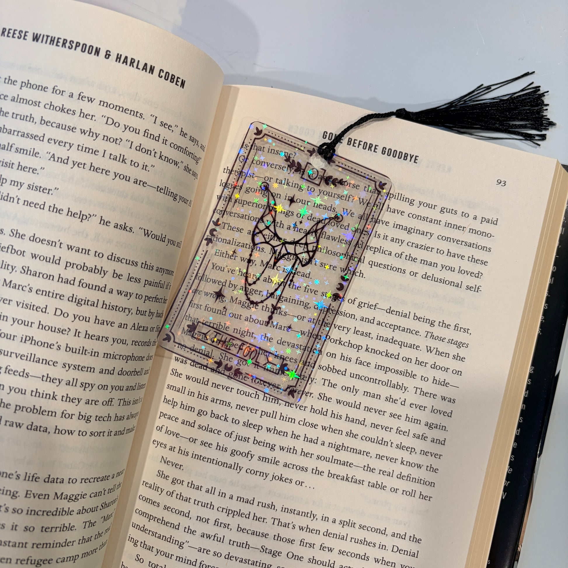 Clear holographic tarot card bookmark with elegant black line art on transparent waterproof cardstock. Finished with a black tassel and shimmering holographic pattern that changes in the light. Available in all 22 Major Arcana designs.