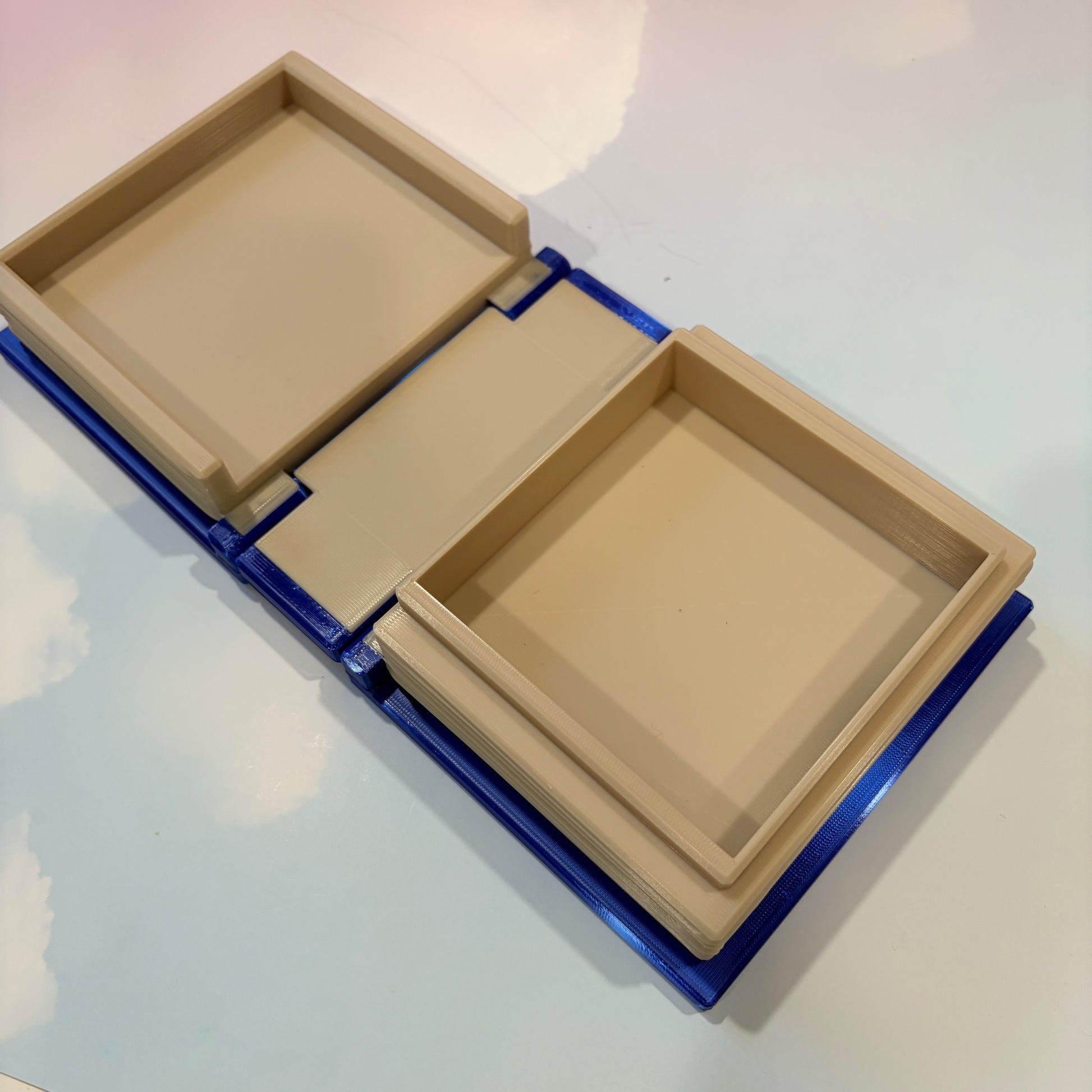 Royal blue and metallic gold 3D printed book box with a celestial moon and stars design on the cover. Opens to reveal a hidden storage compartment that holds 1–2 sets of RPG dice and doubles as a rolling tray. Perfect for jewelry, trinkets, and tabletop gaming accessories.