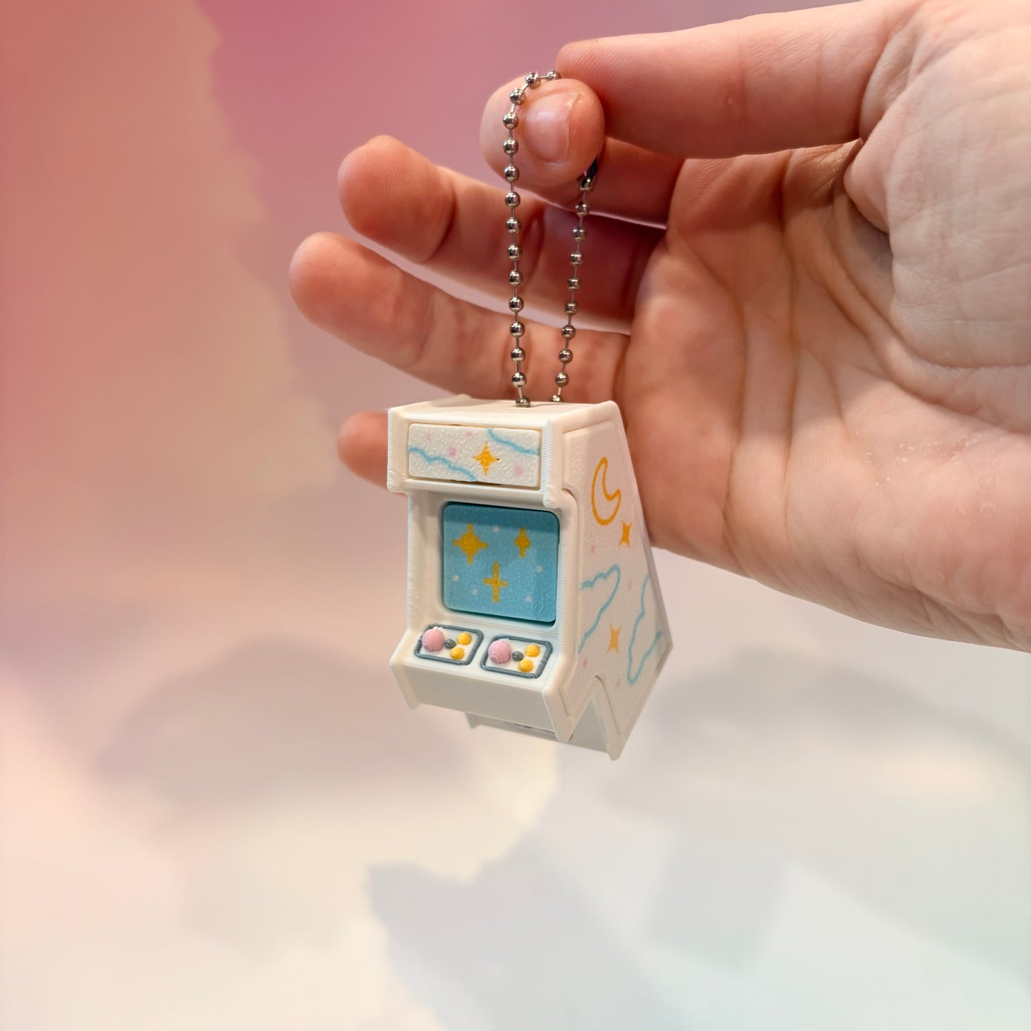 Mini retro arcade machine fidget clicker keychain with pastel color way, blue screen, and 3D printed design, available in clicky or silent.