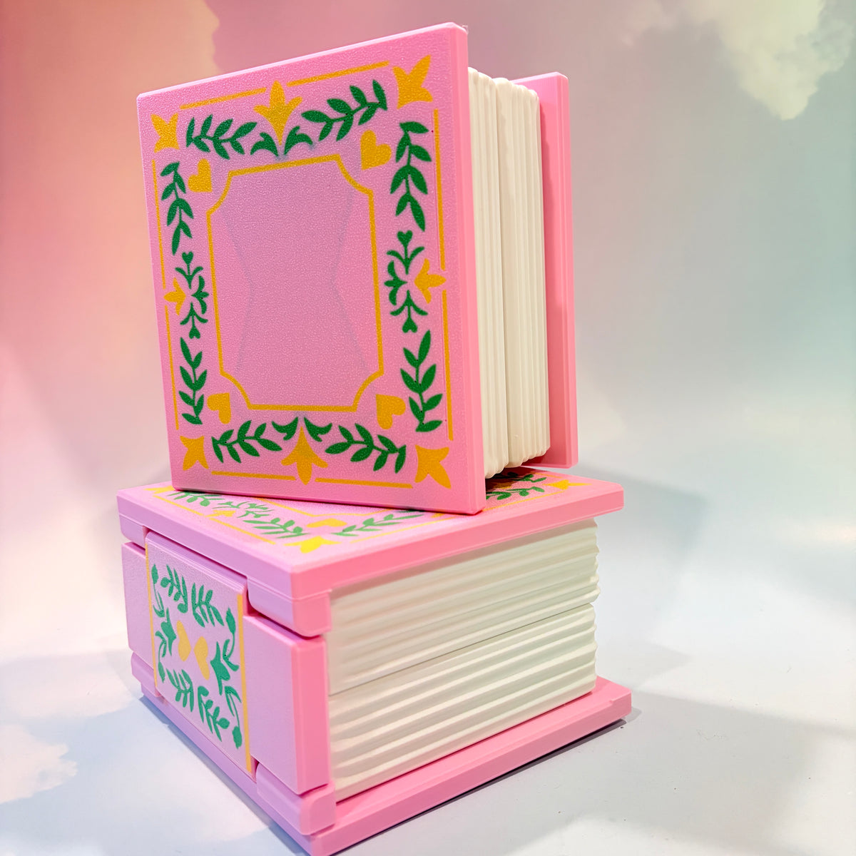 Pink and Green 3D printed book box with a leafy cover. Opens to reveal a hidden storage compartment that holds 1–2 sets of RPG dice and doubles as a rolling tray. Perfect for jewelry, trinkets, and tabletop gaming accessories.