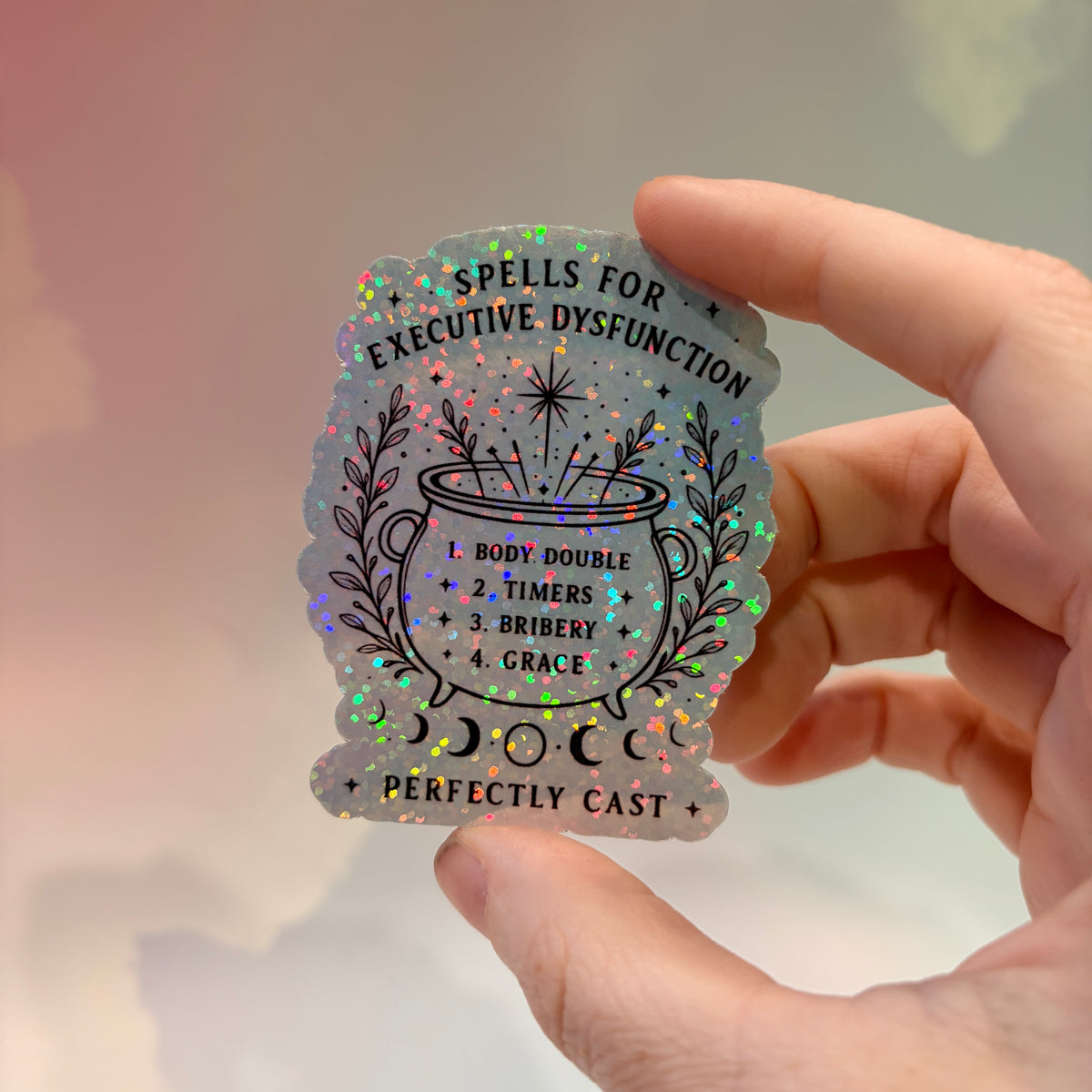Holographic neurodivergent witchy sticker made from water-resistant vinyl, approximately 2.75 inches, featuring magical designs and neurodivergent humor.