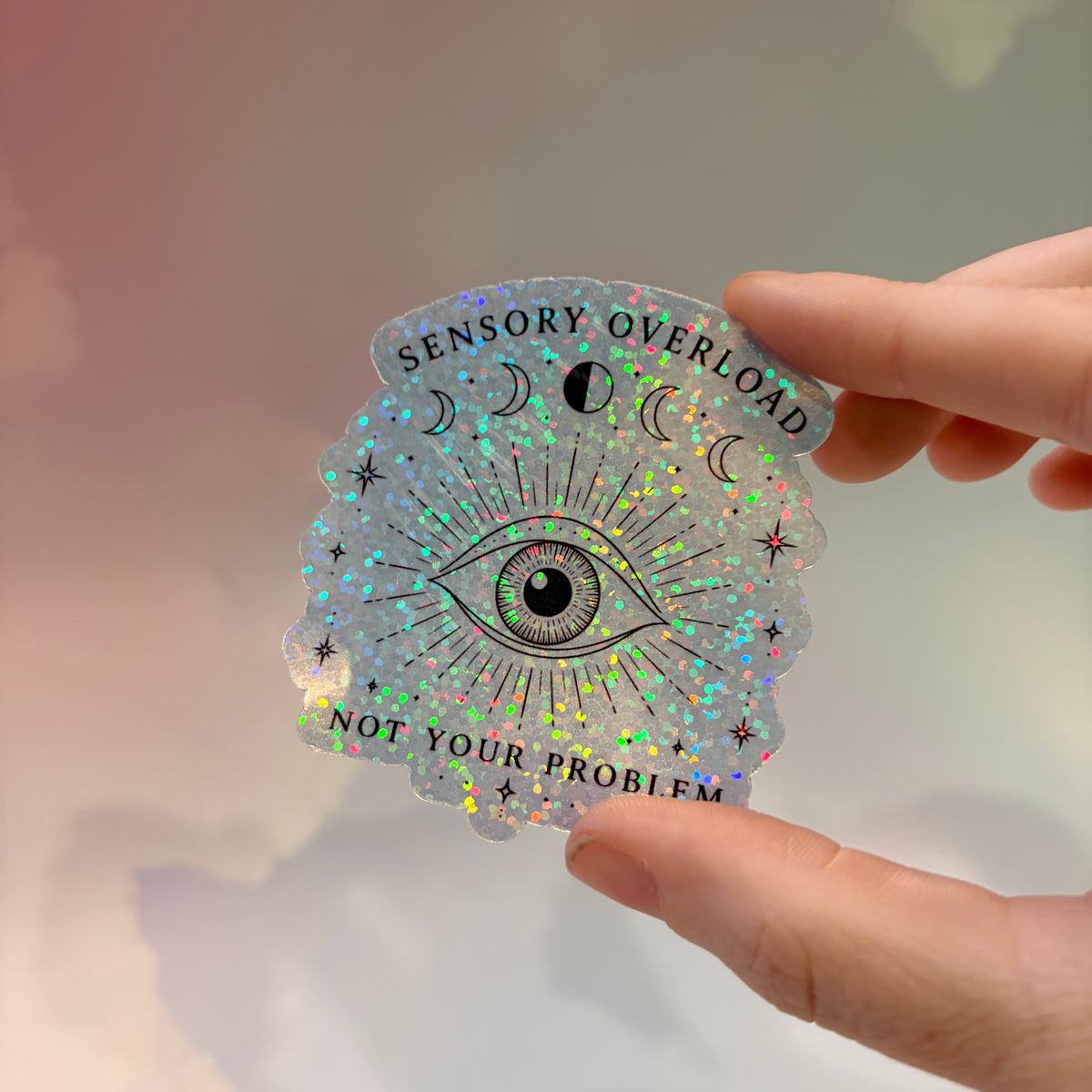 Holographic neurodivergent witchy sticker made from water-resistant vinyl, approximately 2.75 inches, featuring magical designs and neurodivergent humor.