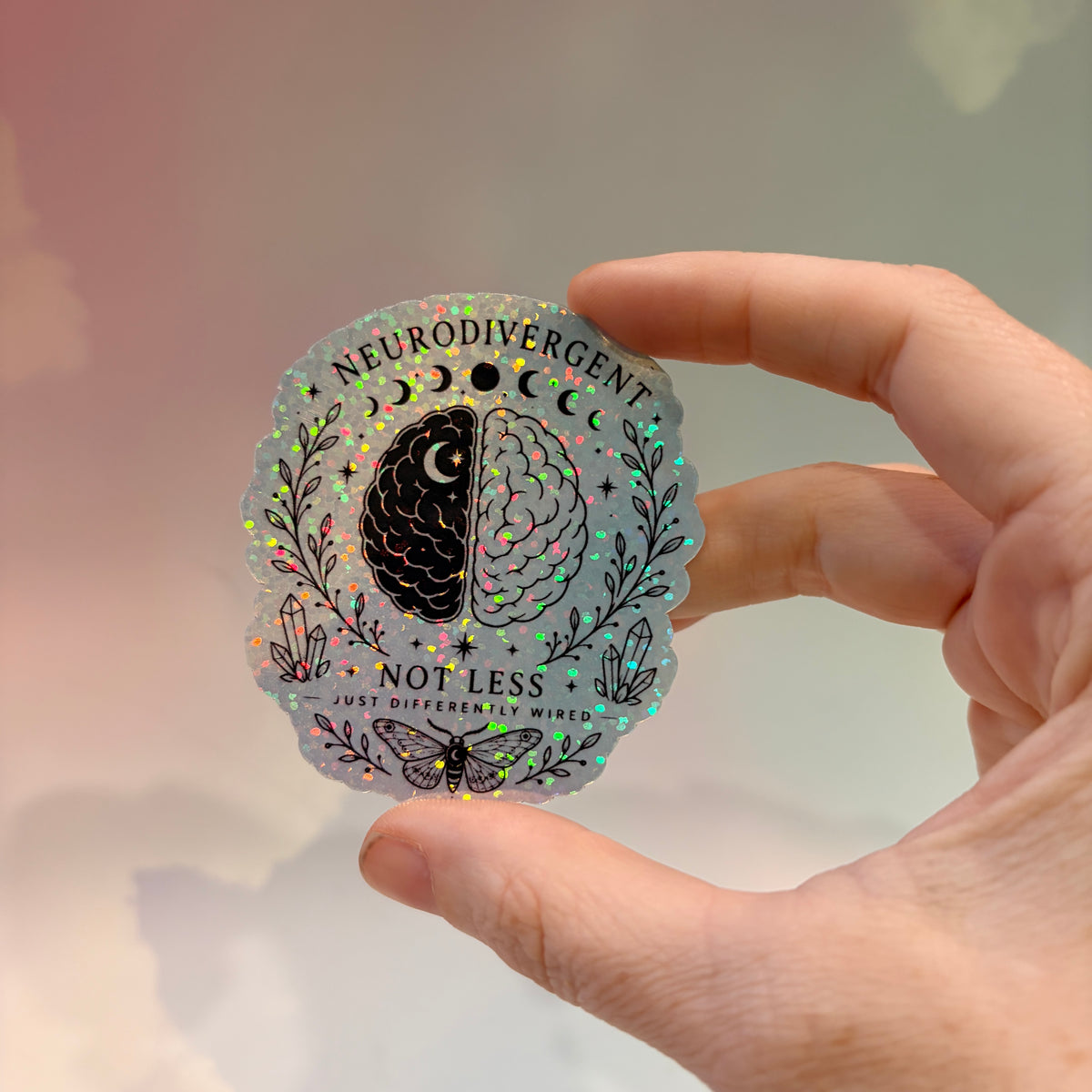 Holographic neurodivergent witchy sticker made from water-resistant vinyl, approximately 2.75 inches, featuring magical designs and neurodivergent humor.