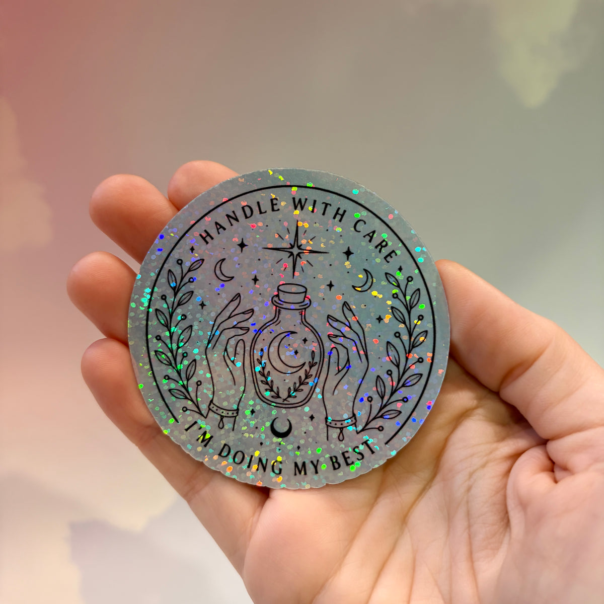 Holographic neurodivergent witchy sticker made from water-resistant vinyl, approximately 2.75 inches, featuring magical designs and neurodivergent humor.