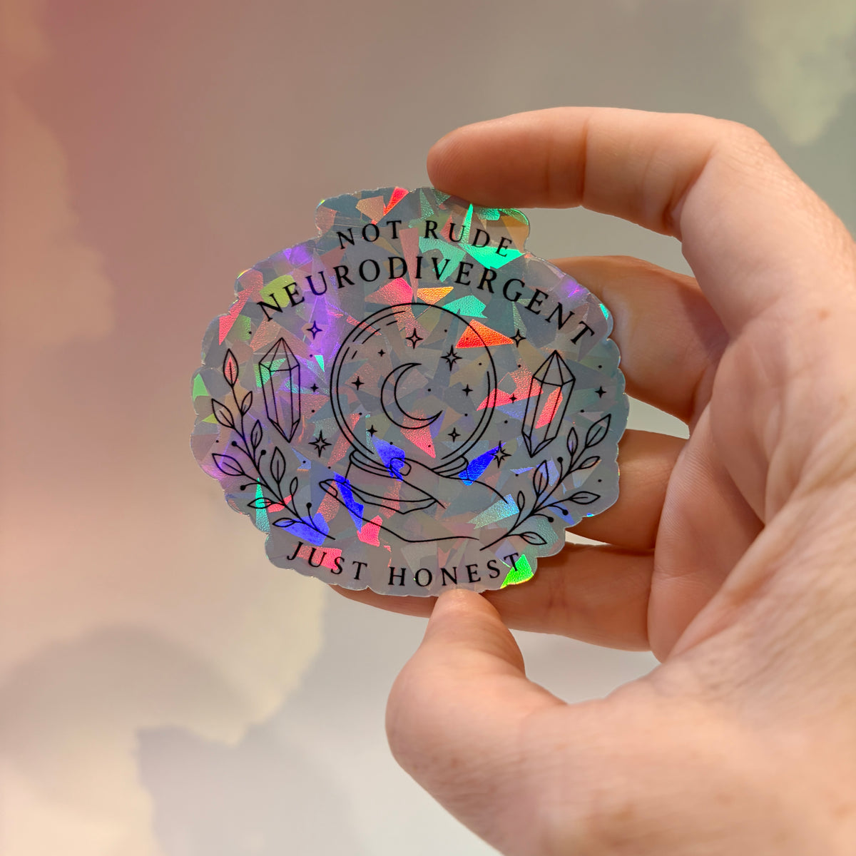 Holographic neurodivergent witchy sticker made from water-resistant vinyl, approximately 2.75 inches, featuring magical designs and neurodivergent humor.