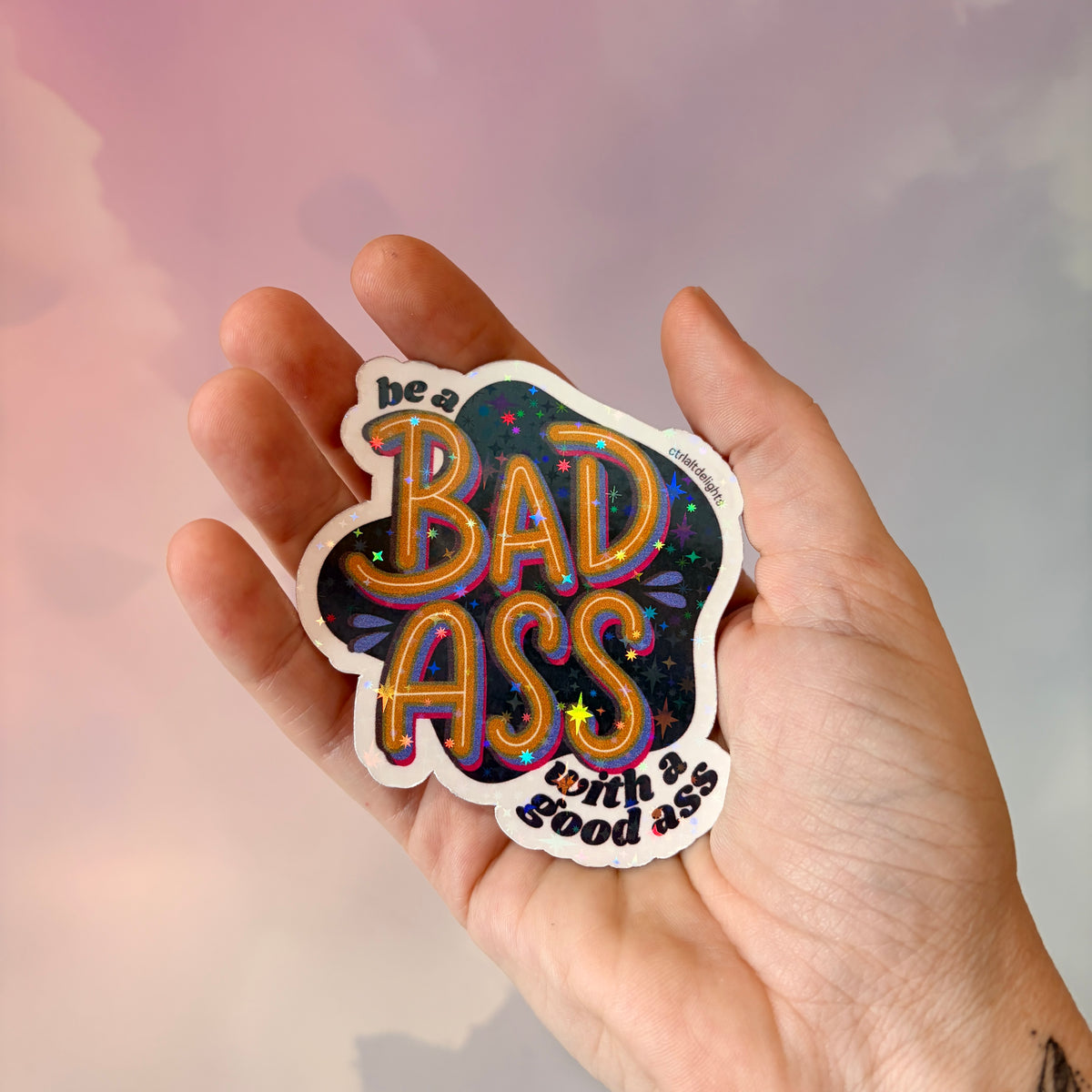 This vibrant vinyl sticker with the phrase 'Be a Badass with a Good Ass' is perfect for adding motivational flair to your laptop, water bottle, or journal. The playful yet bold design is sure to inspire confidence wherever you place it.