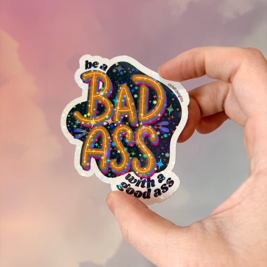This vibrant vinyl sticker with the phrase 'Be a Badass with a Good Ass' is perfect for adding motivational flair to your laptop, water bottle, or journal. The playful yet bold design is sure to inspire confidence wherever you place it.