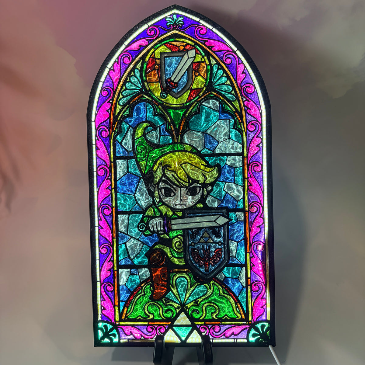 Handmade Zelda-inspired stained glass window light featuring hand-tinted resin artwork in a 3D printed frame with glowing interior LED lighting.