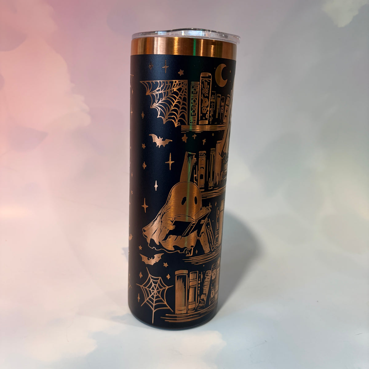 20oz laser engraved skinny tumbler featuring Halloween books, ghosts, bats, and spiderwebs. Perfect spooky drinkware for witchy book lovers and gothic décor fans.