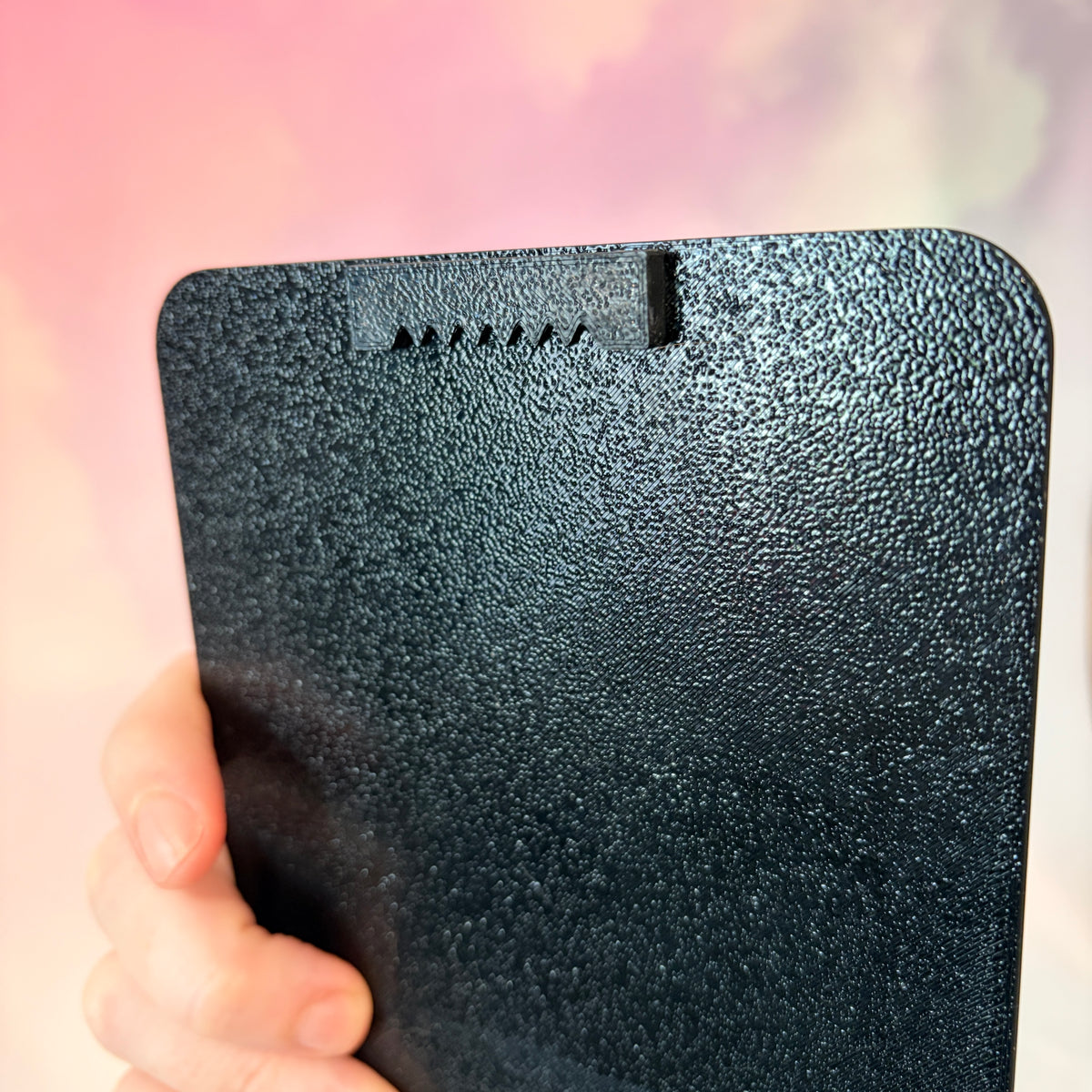 A vertical 3D printed tarot card sign featuring The Moon from the Major Arcana, displayed upright on a small black easel against a soft pink, peach, and lavender background. All 22 Major Arcana tarot card designs are available, allowing customers to choose a card that reflects their interests, spiritual practice, or personal journey.