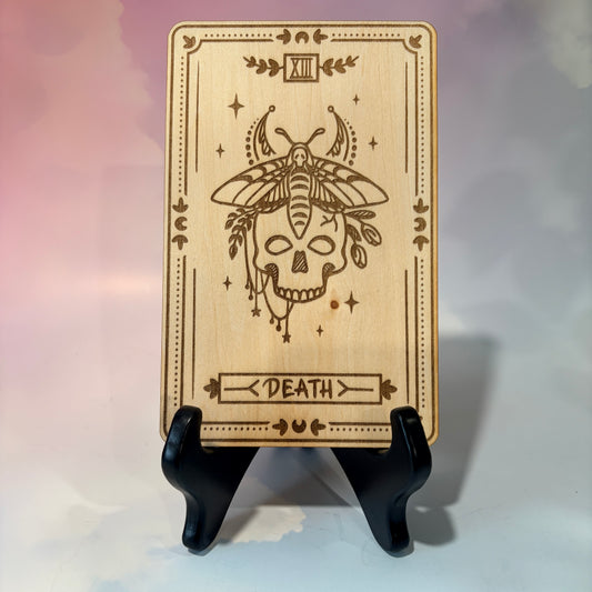 Laser-engraved wooden tarot card made from 3mm basswood, approximately 7 x 5 inches. Available in all 22 Major Arcana designs with customizable colors and an optional display stand for an additional $2.
