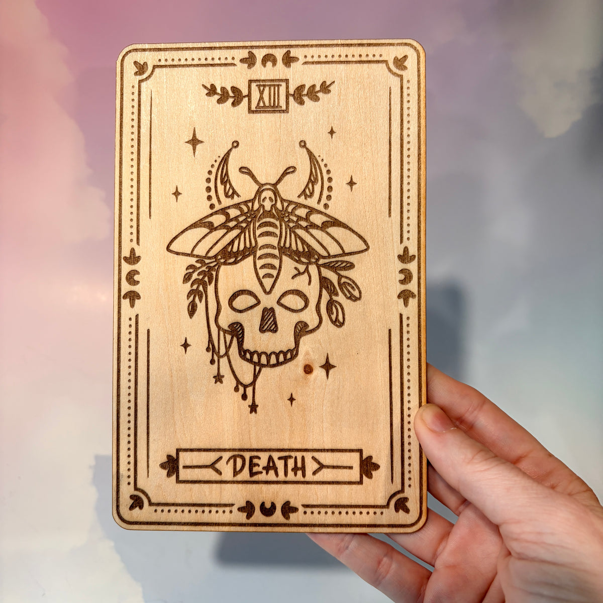 Laser-engraved wooden tarot card made from 3mm basswood, approximately 7 x 5 inches. Available in all 22 Major Arcana designs with customizable colors and an optional display stand for an additional $2.
