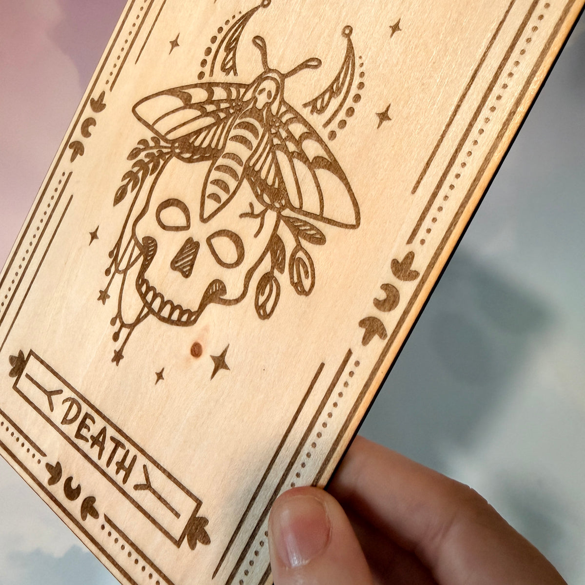 Laser-engraved wooden tarot card made from 3mm basswood, approximately 7 x 5 inches. Available in all 22 Major Arcana designs with customizable colors and an optional display stand for an additional $2.
