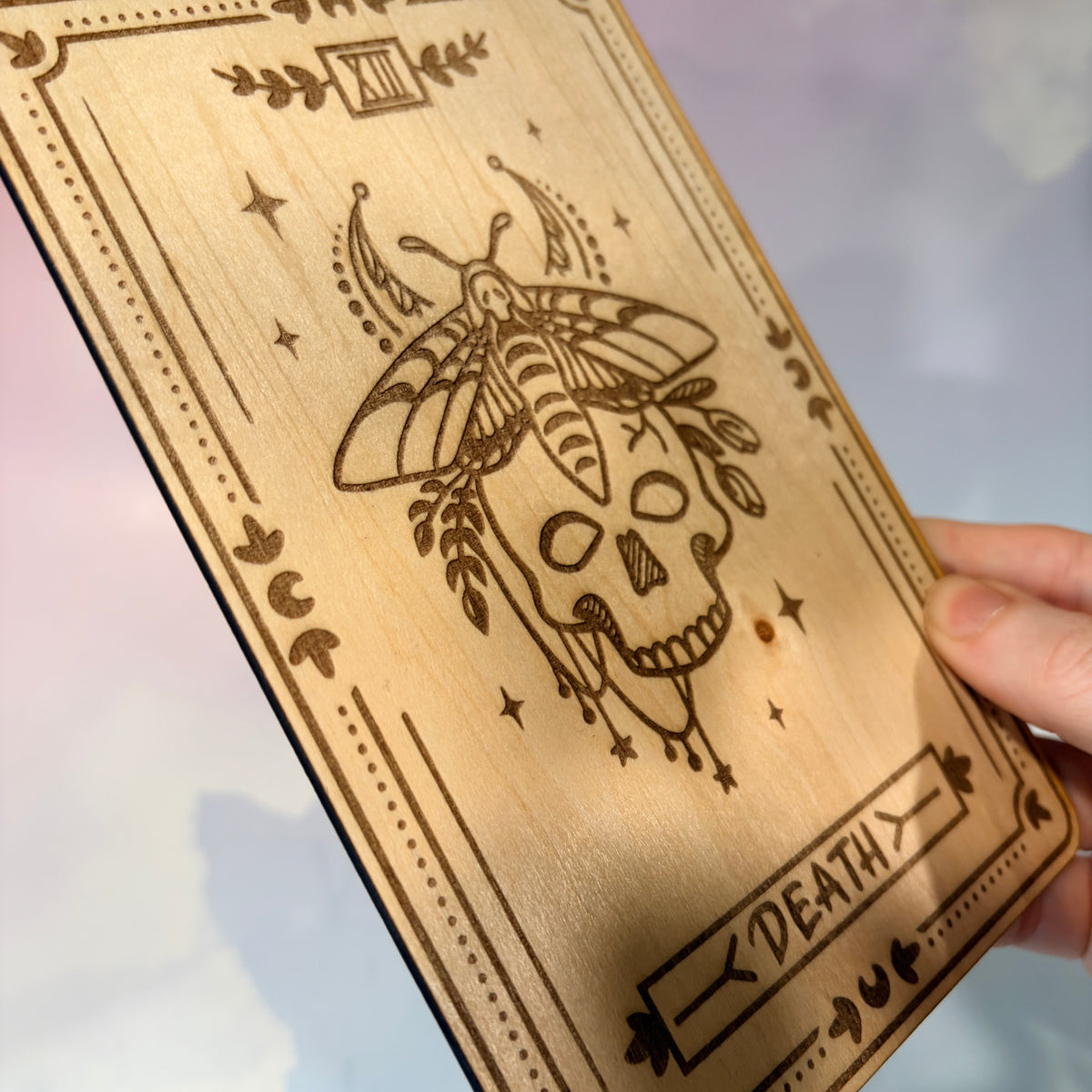 Laser-engraved wooden tarot card made from 3mm basswood, approximately 7 x 5 inches. Available in all 22 Major Arcana designs with customizable colors and an optional display stand for an additional $2.
