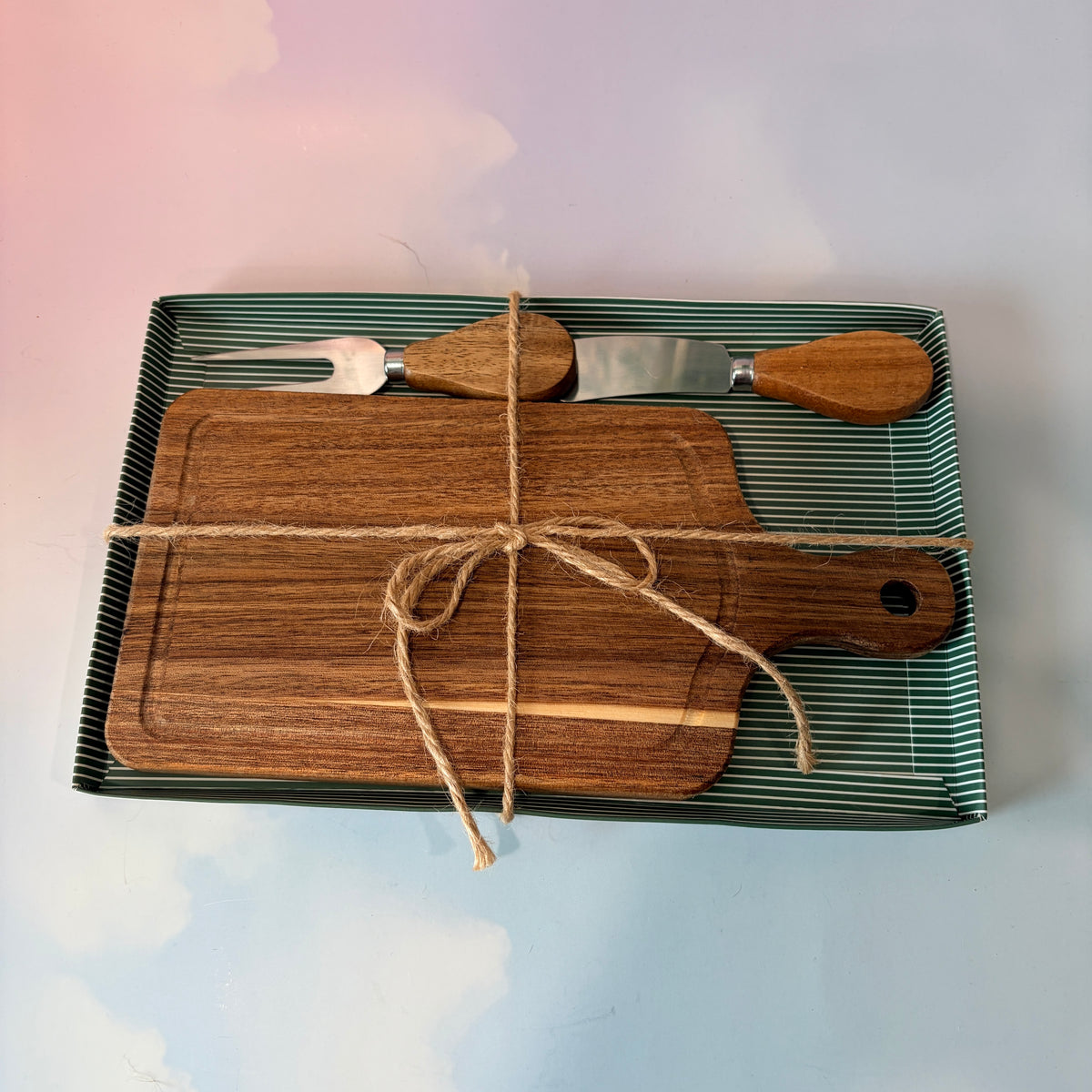 Personalized mini acacia wood charcuterie board with custom laser engraving, approximately 9.5 x 4.7 inches. Includes two serving tools, standard or cursive font options, and gift wrapping for a ready-to-give present.

