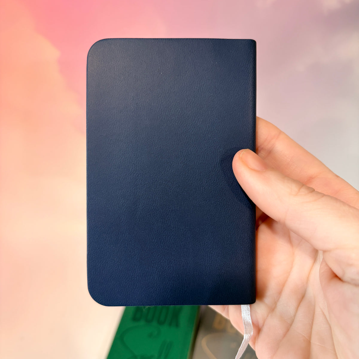 Mini green leather notebook with “Book of Spells” laser engraved on the cover in black lettering. Approximately 4 x 2.5 inches, with 50 lined pages. Available in brown, green, blue, gray, and black.
