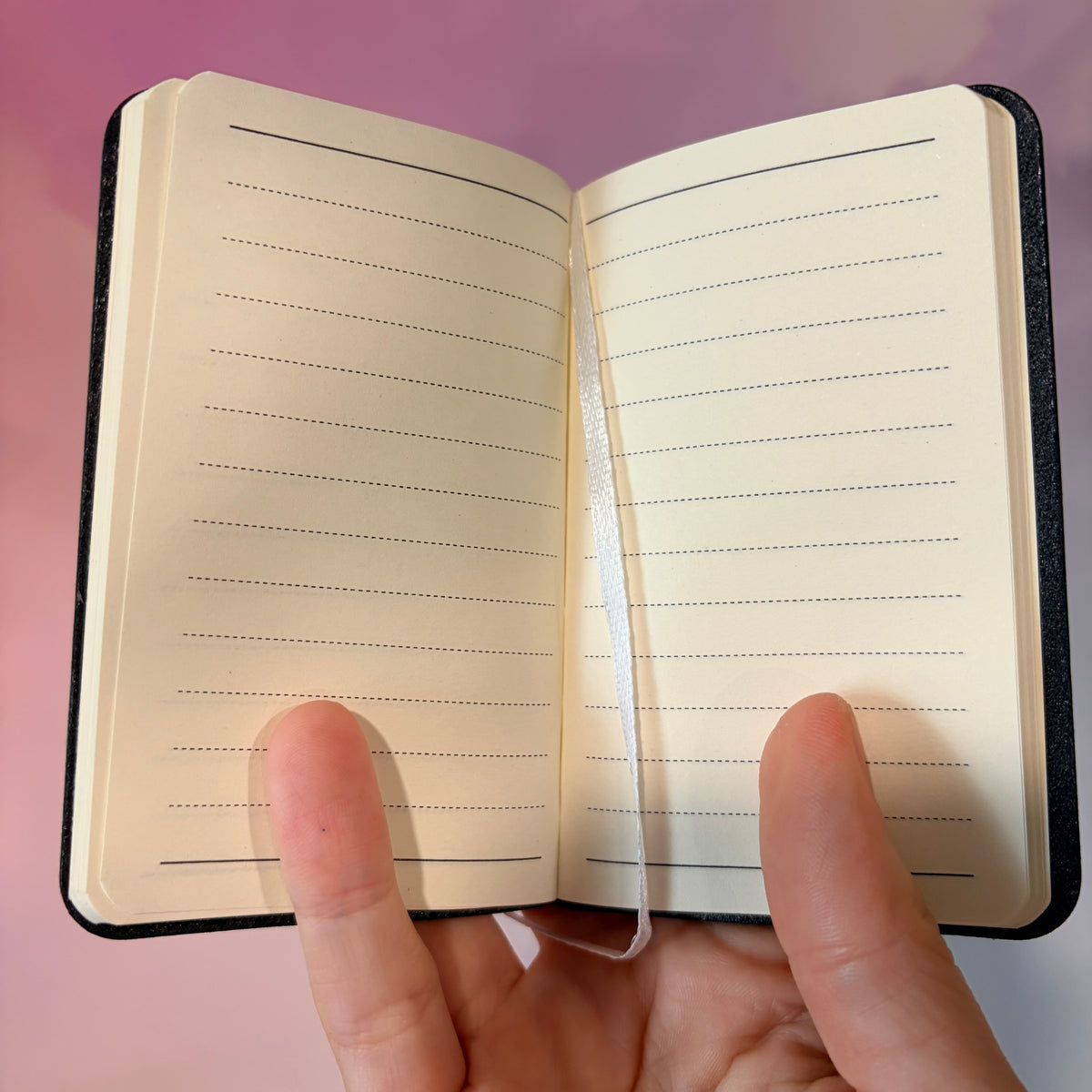 Mini blue notebook with “People I Plan to Haunt” laser engraved in black lettering and a tiny ghost illustration. Approximately 4 x 2.5 inches, with 50 lined pages. Available in brown, green, blue, gray, and black.
