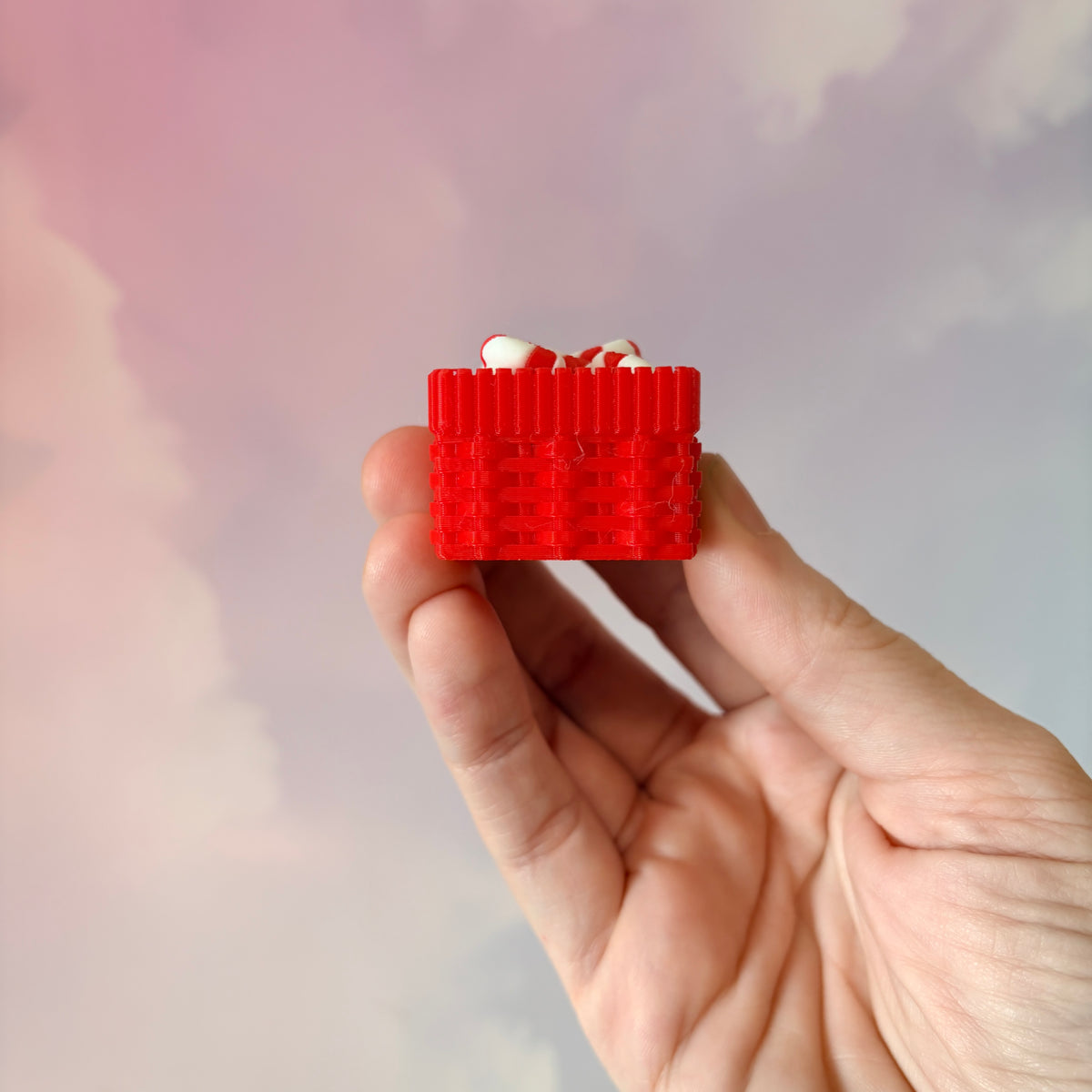 3D printed Christmas fidget clicker featuring a red basket filled with red-and-white candy canes. Available with a clicky or silent mechanism. A festive holiday sensory toy and stocking stuffer for Christmas lovers.
