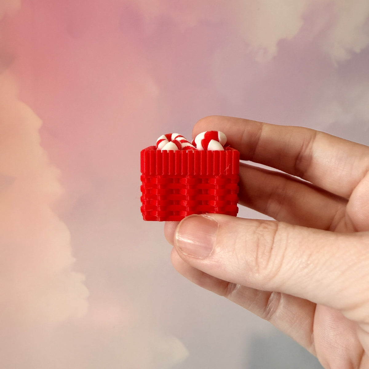 3D printed Christmas fidget clicker featuring a red basket filled with red-and-white candy canes. Available with a clicky or silent mechanism. A festive holiday sensory toy and stocking stuffer for Christmas lovers.