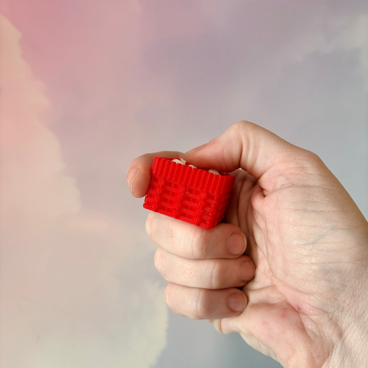 3D printed Christmas fidget clicker featuring a red basket filled with red-and-white candy canes. Available with a clicky or silent mechanism. A festive holiday sensory toy and stocking stuffer for Christmas lovers.