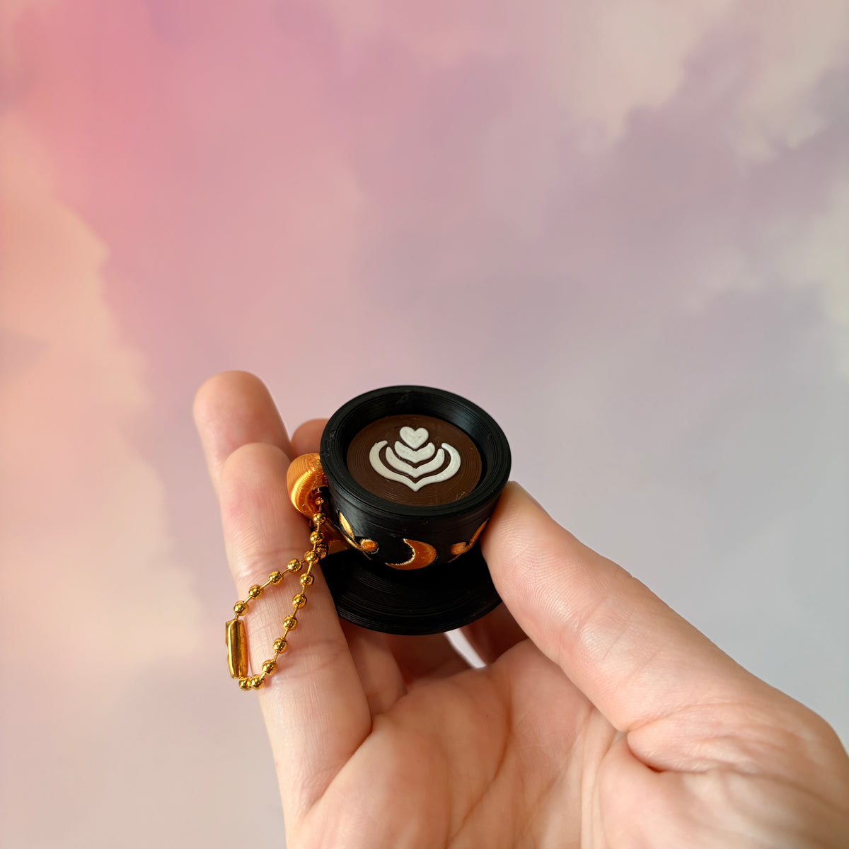 3D printed mystical drink cup fidget clicker keychain with a black floral moon design in gold or silver. Choose matcha or coffee with cute latte art, plus a clicky or silent mechanism.