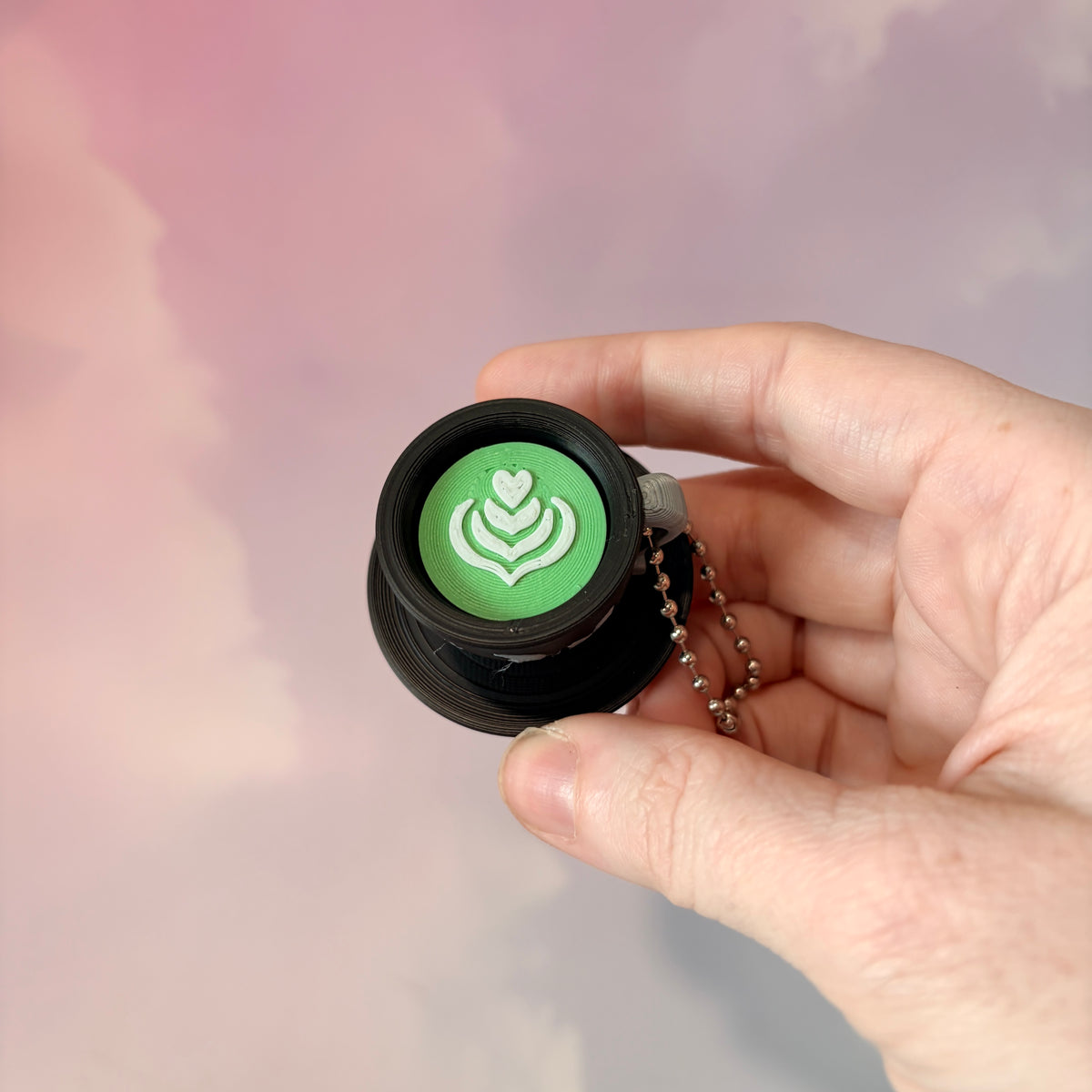 3D printed mystical drink cup fidget clicker keychain with a black floral moon design in gold or silver. Choose matcha or coffee with cute latte art, plus a clicky or silent mechanism.