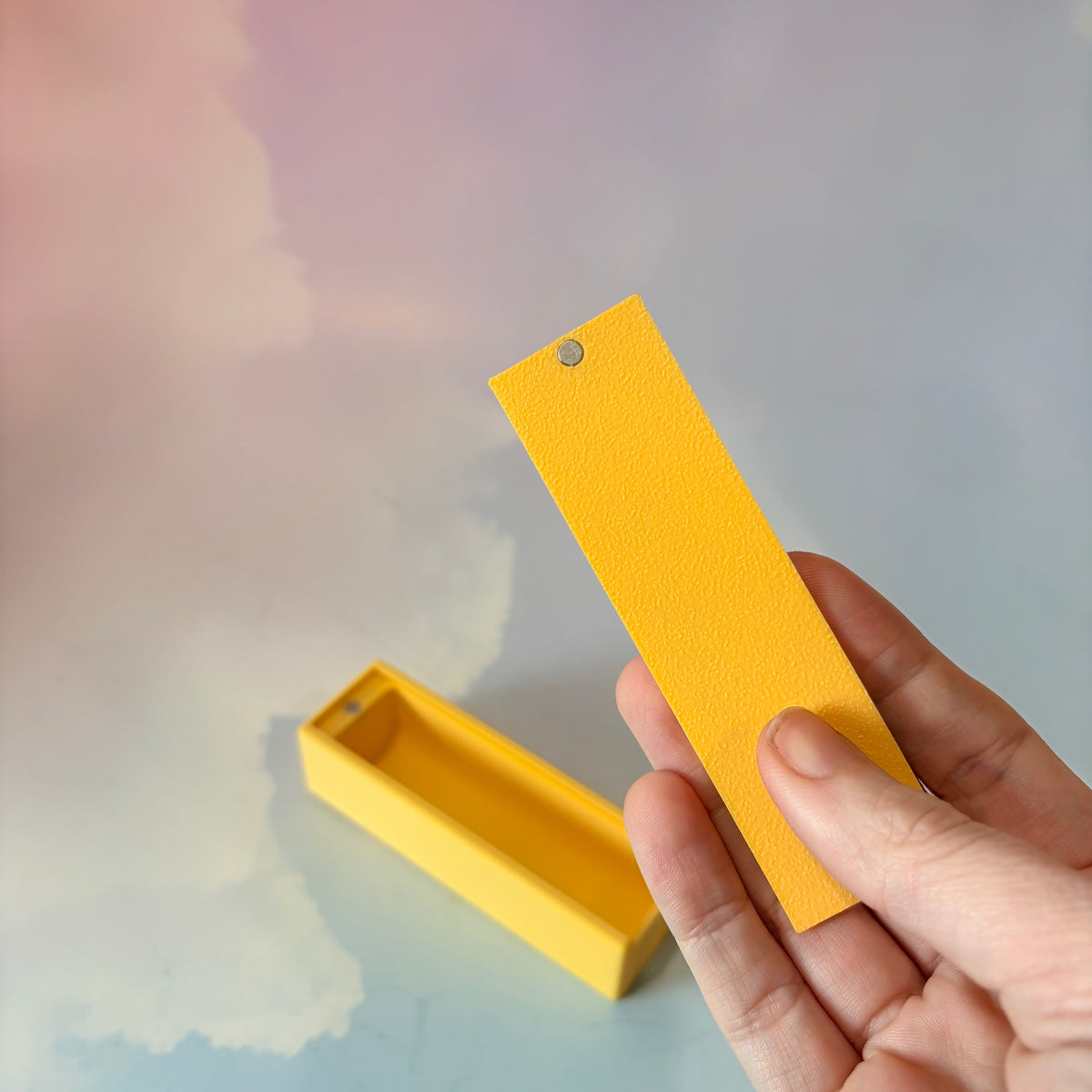 3D printed stick of butter bag charm with gold hardware, classic TBSP markings, Grade AA label, and net weight details. Sliding top hides a lipstick or chapstick in a magnetic compartment.