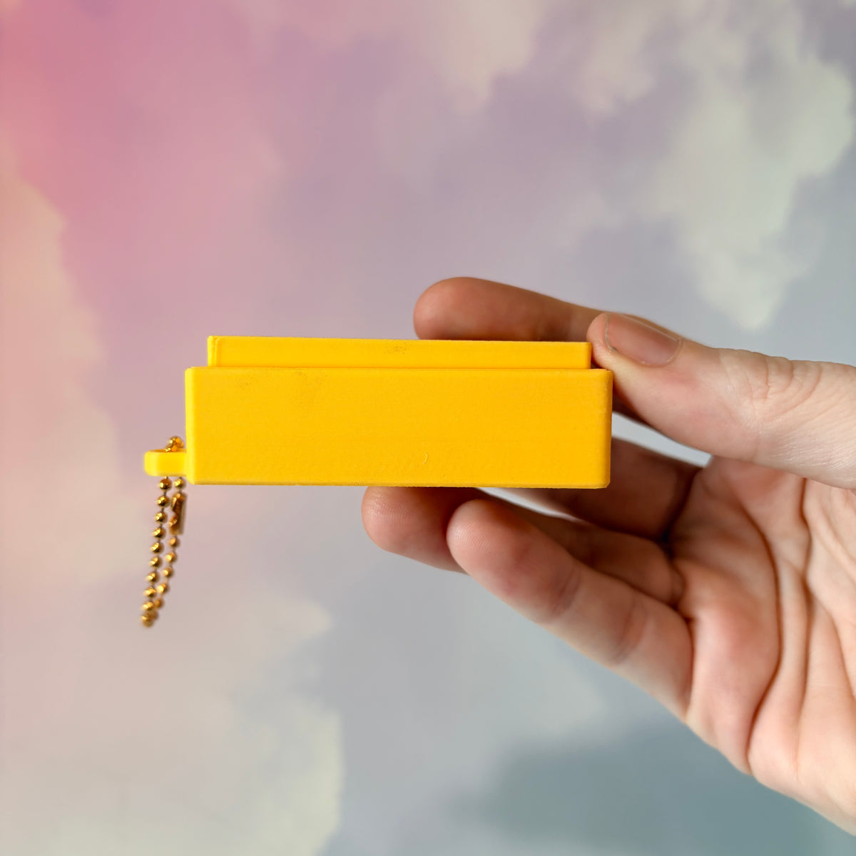 3D printed stick of butter fidget clicker keychain with classic tablespoon marking lines, gold-tone hardware, and two satisfying clicky key switches, perfect for foodies and whimsical accessory lovers.