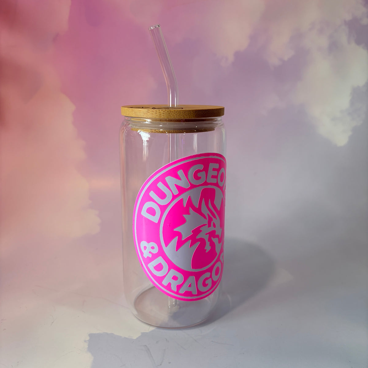 16 oz Dungeons and Dragons glass coffee can with vinyl fantasy design, bamboo lid engraved with two D20 dice, and straw. Custom colors available. Handwash only; not dishwasher or microwave safe.