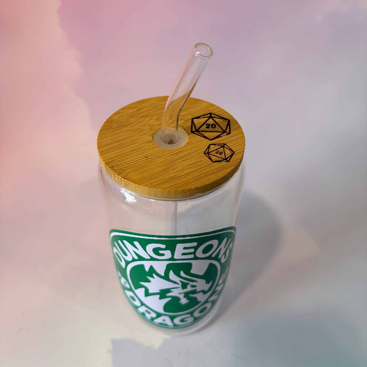 16 oz Dungeons and Dragons glass coffee can with vinyl fantasy design, bamboo lid engraved with two D20 dice, and straw. Custom colors available. Handwash only; not dishwasher or microwave safe.