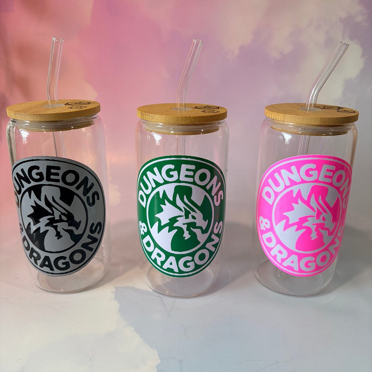 16 oz Dungeons and Dragons glass coffee can with vinyl fantasy design, bamboo lid engraved with two D20 dice, and straw. Custom colors available. Handwash only; not dishwasher or microwave safe.
