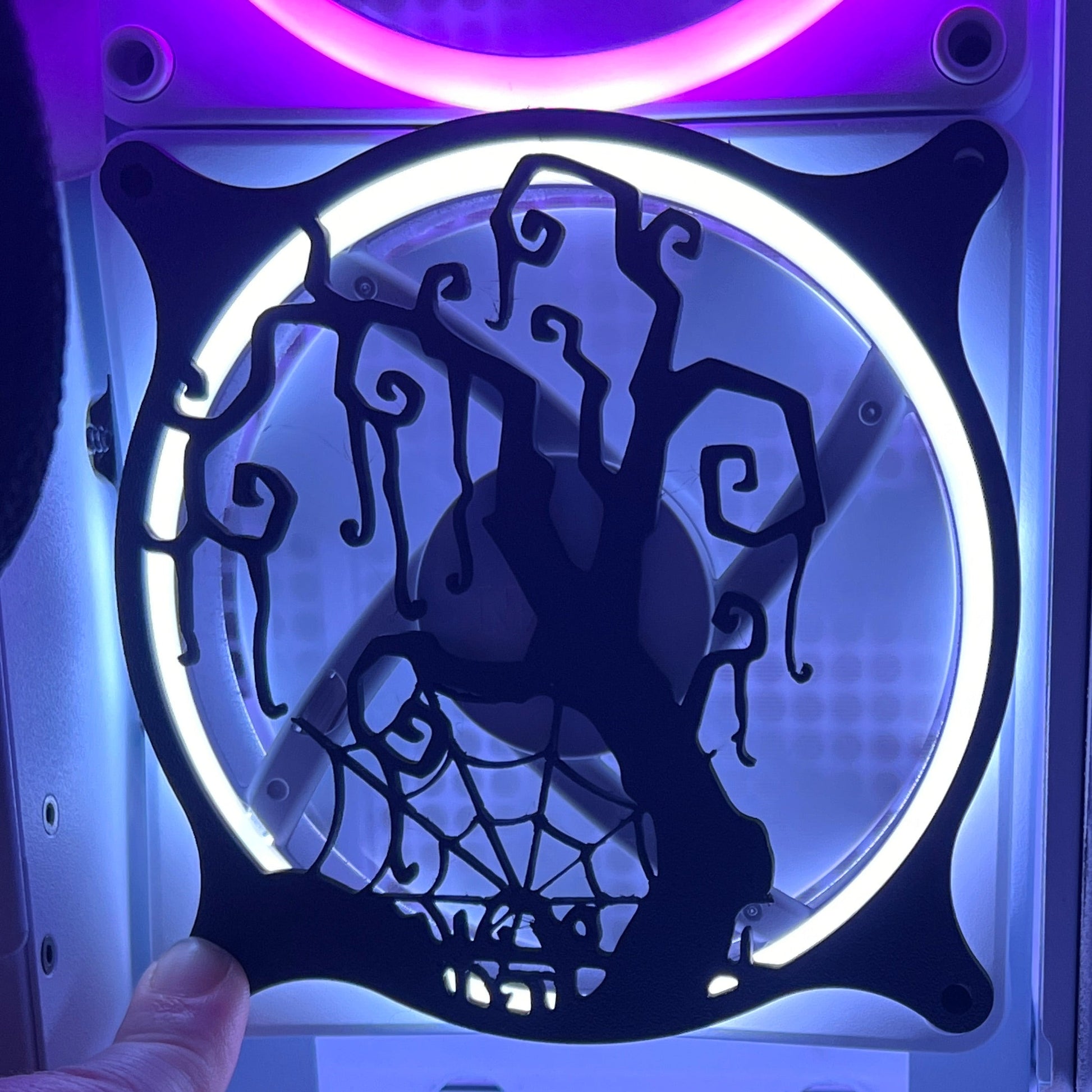 Decorative PC fan cover featuring a twisted tree and spider web design, ideal for adding a spooky touch to your gaming setup. Crafted from high-quality materials, this cover is compatible with standard 120mm fans. Featured on a rainbow LED fan.