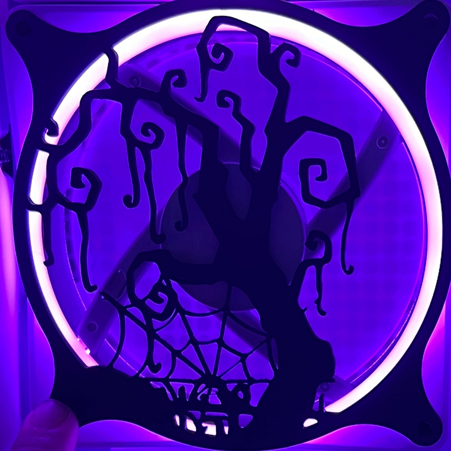 Decorative PC fan cover featuring a twisted tree and spider web design, ideal for adding a spooky touch to your gaming setup. Crafted from high-quality materials, this cover is compatible with standard 120mm fans. Featured on a rainbow LED fan.