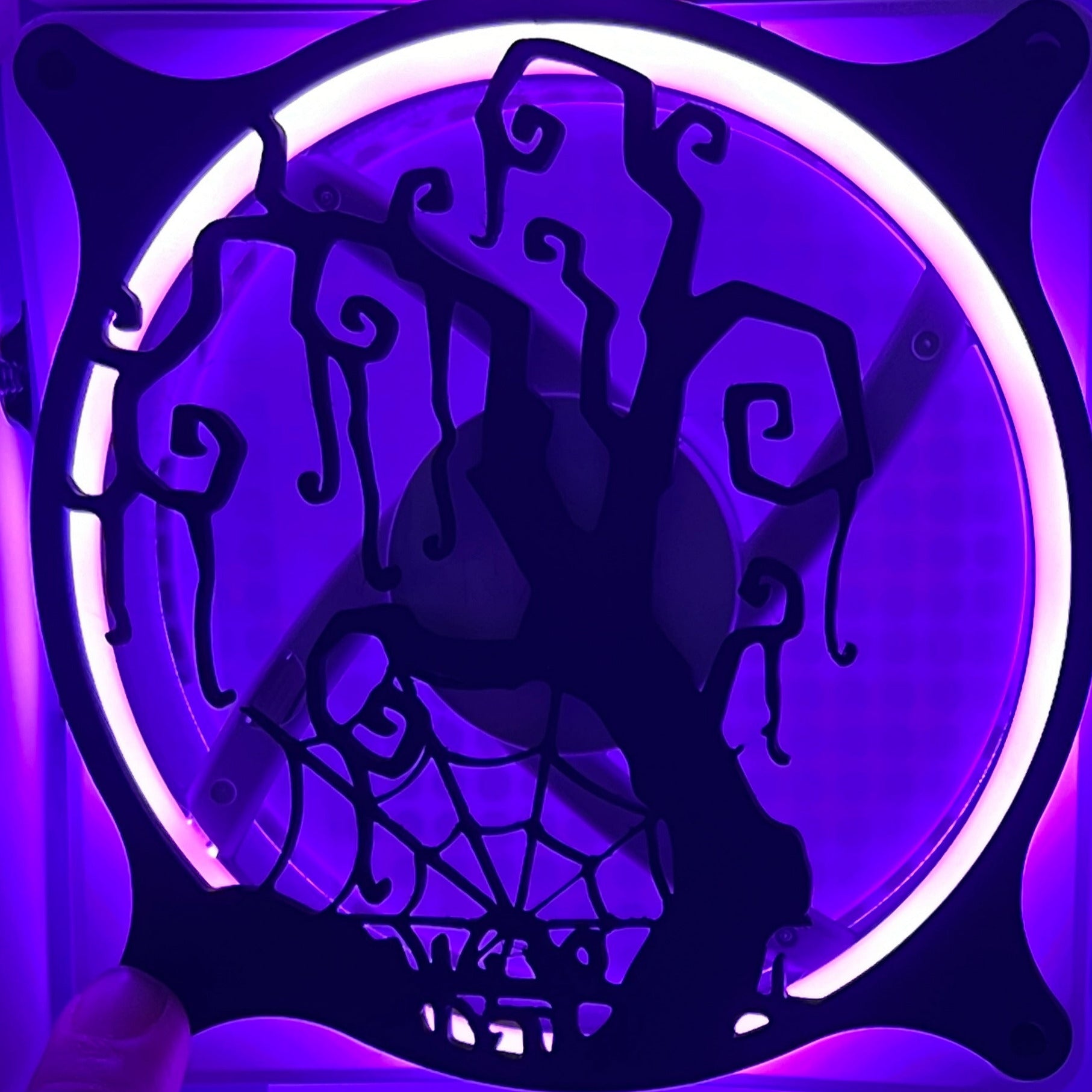 Decorative PC fan cover featuring a twisted tree and spider web design, ideal for adding a spooky touch to your gaming setup. Crafted from high-quality materials, this cover is compatible with standard 120mm fans. Featured on a rainbow LED fan.