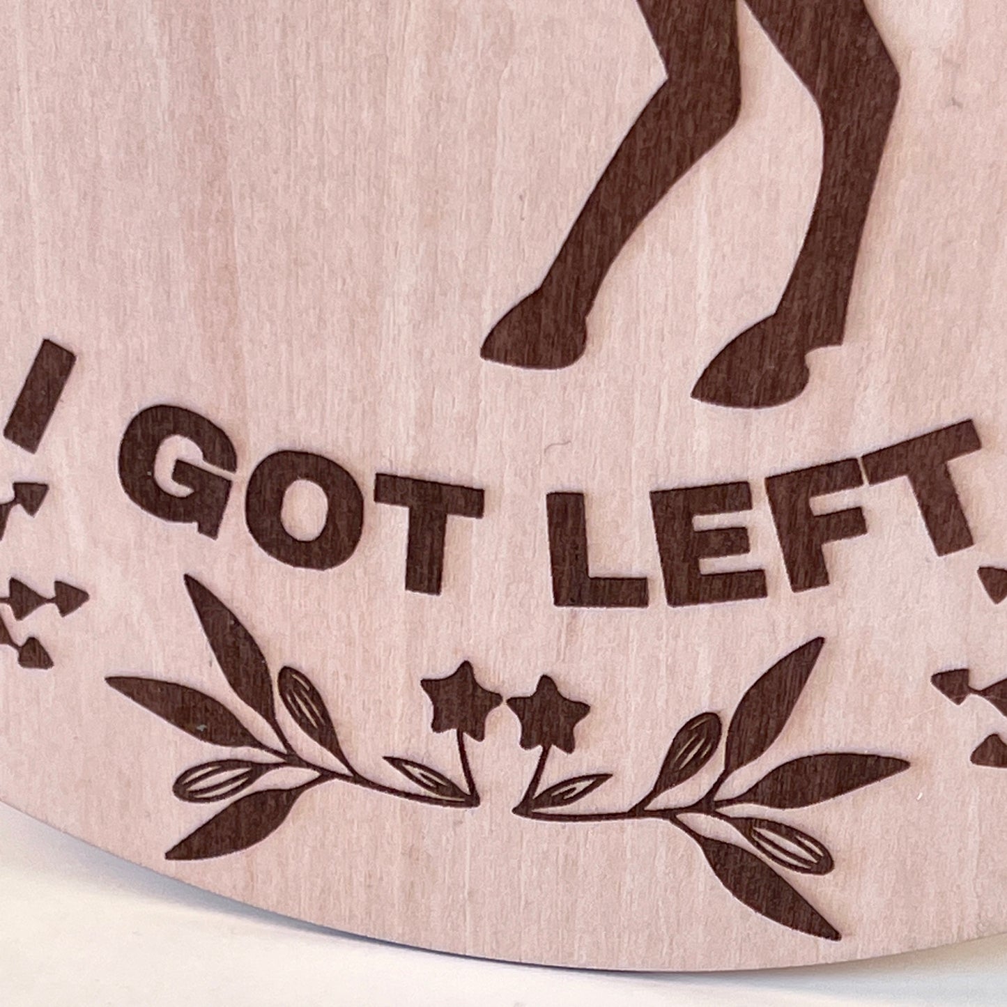 Laser-engraved wood sign featuring 'Not Sure How Many Yeehaws I Got Left,' decorated with a horse silhouette, floral accents, and a rustic bow.