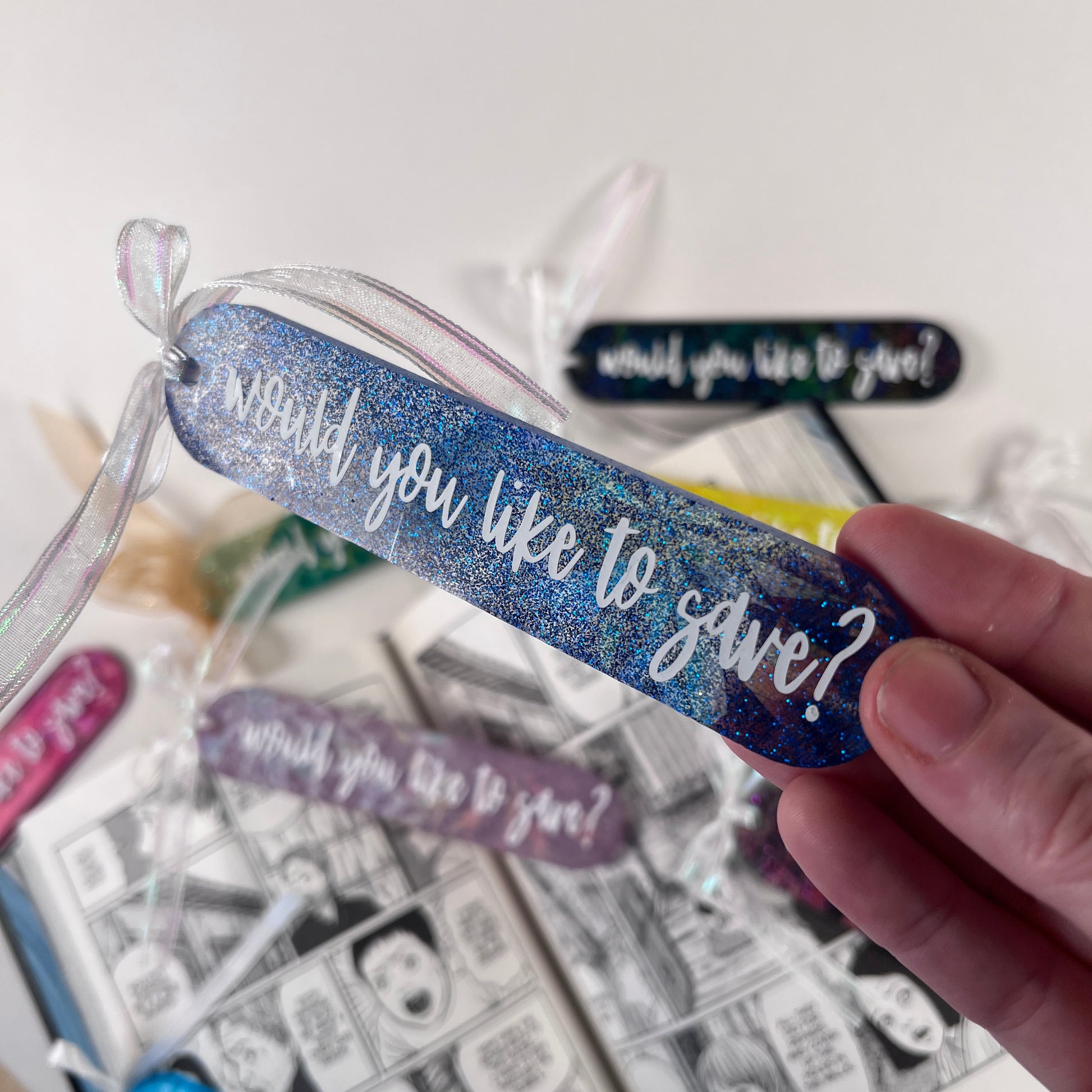 Handmade resin bookmark for gamers featuring 'Would you like to save?' design, vibrant colors, and glittery details. Perfect gift for RPG fans.