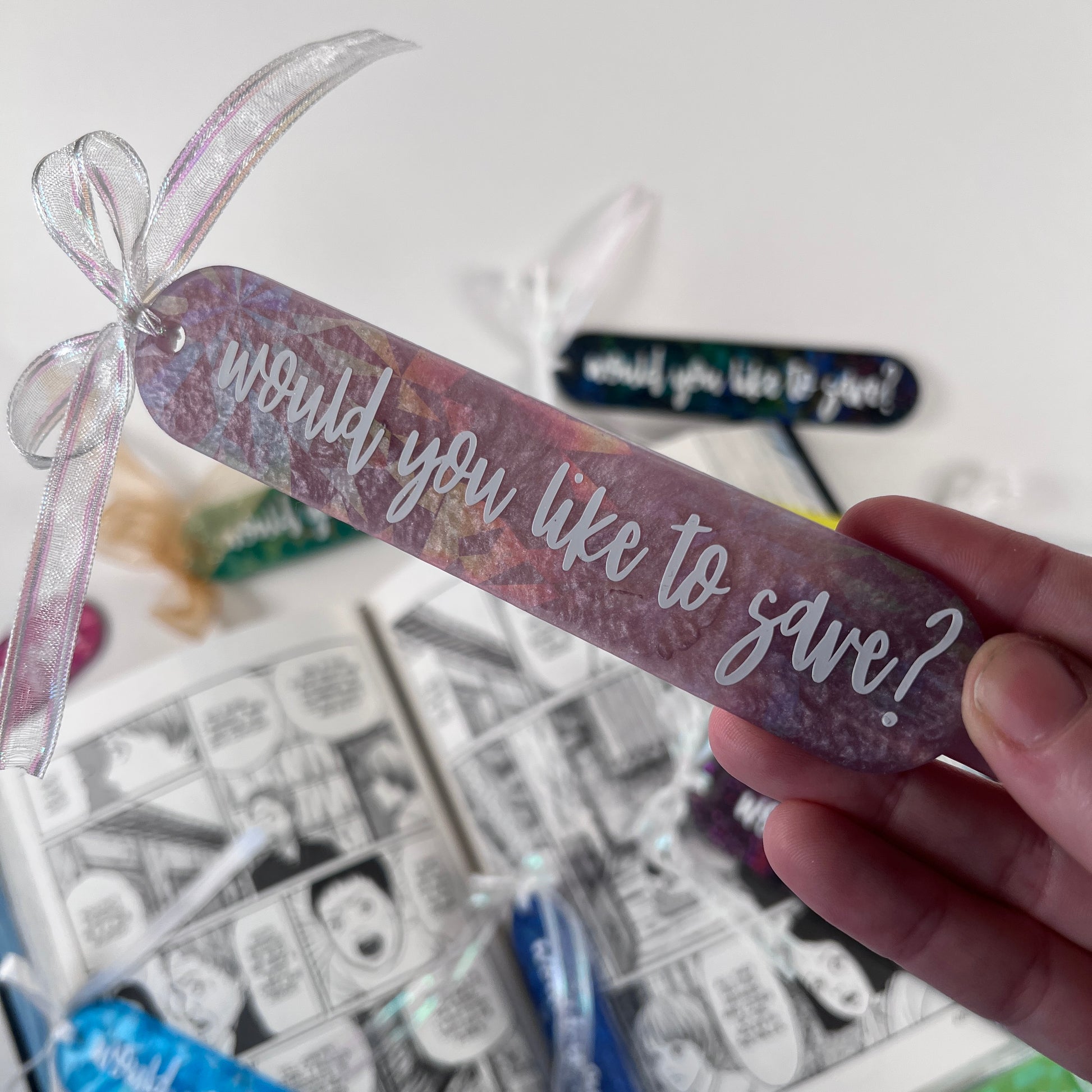 Handmade resin bookmark for gamers featuring 'Would you like to save?' design, vibrant colors, and glittery details. Perfect gift for RPG fans.