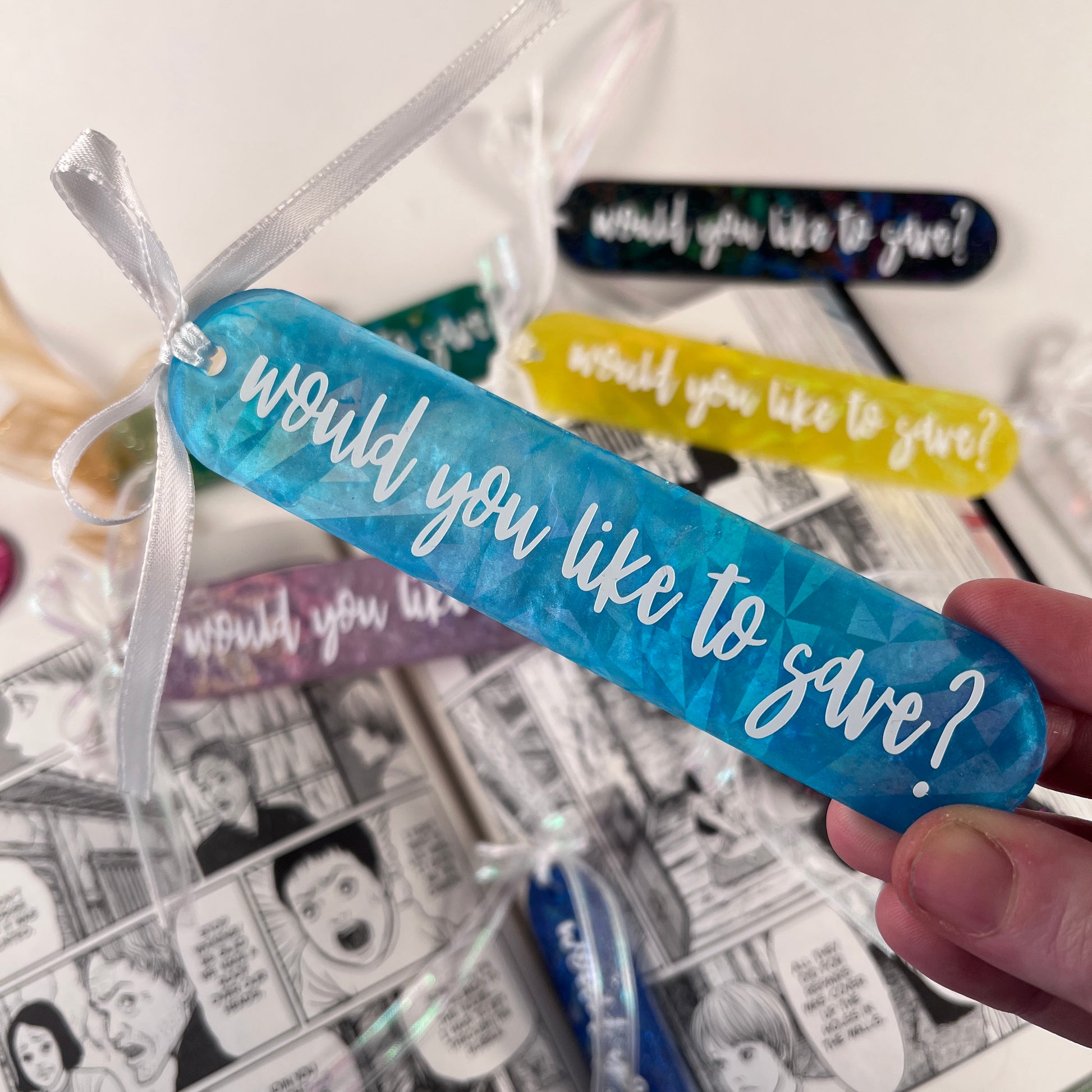 Handmade resin bookmark for gamers featuring 'Would you like to save?' design, vibrant colors, and glittery details. Perfect gift for RPG fans.