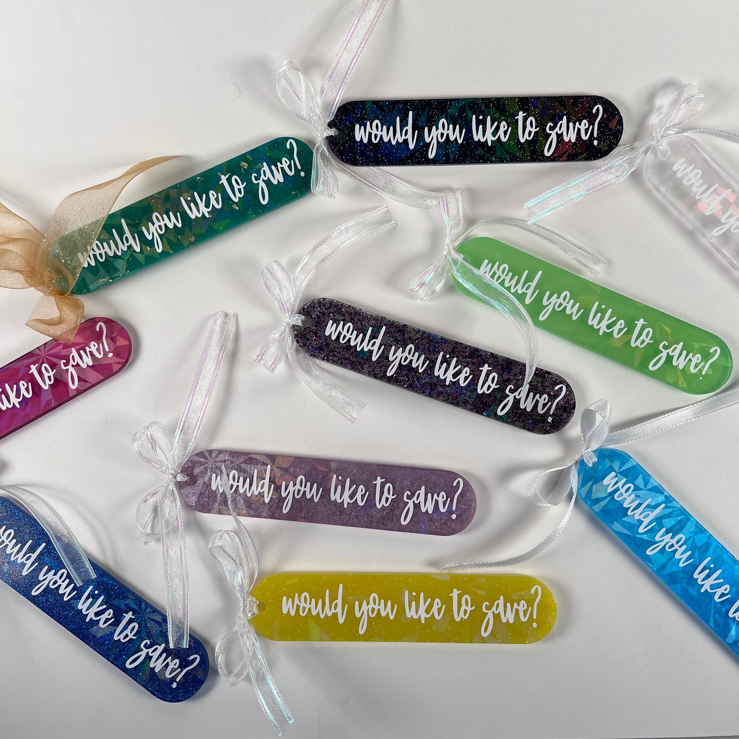 Handmade resin bookmark for gamers featuring 'Would you like to save?' design, vibrant colors, and glittery details. Perfect gift for RPG fans.