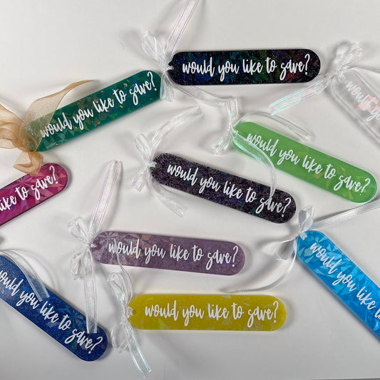Handmade resin bookmark for gamers featuring 'Would you like to save?' design, vibrant colors, and glittery details. Perfect gift for RPG fans.