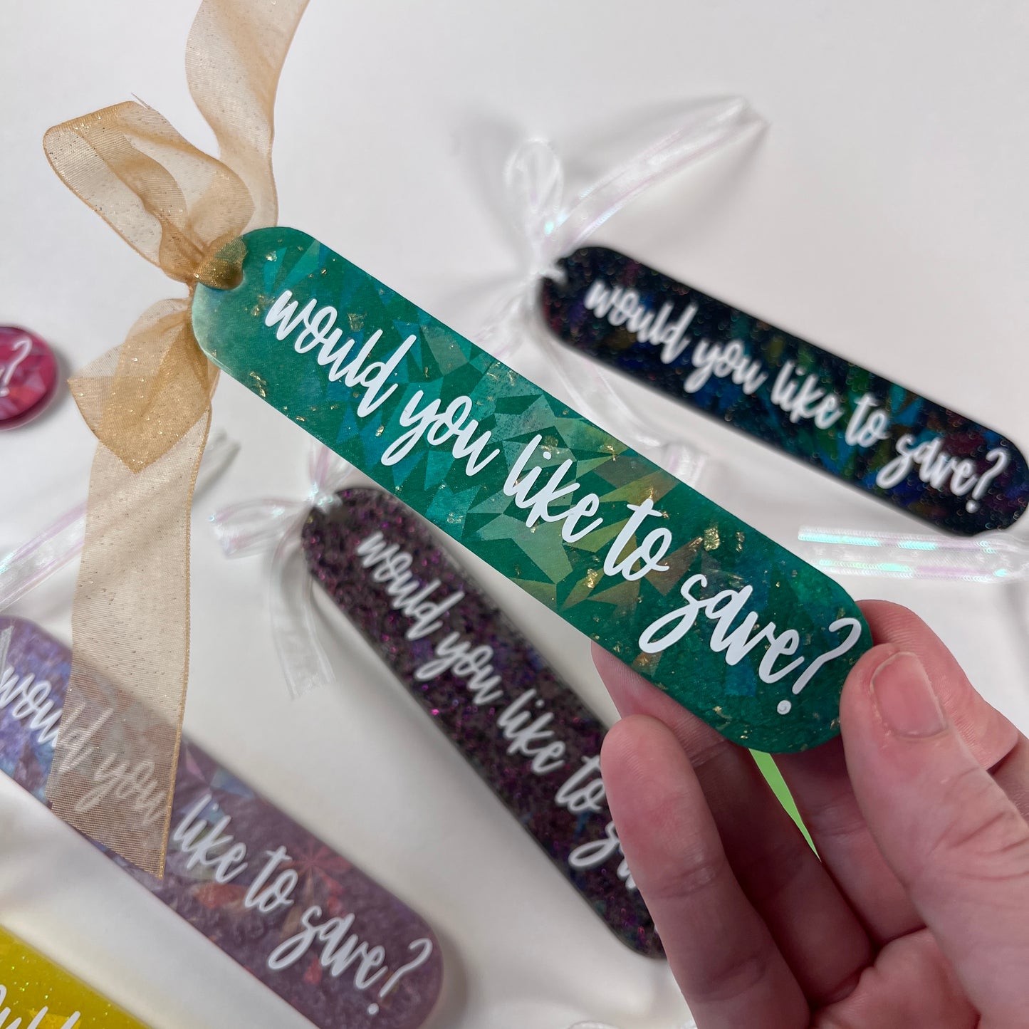 Handmade resin bookmark for gamers featuring 'Would you like to save?' design, vibrant colors, and glittery details. Perfect gift for RPG fans.