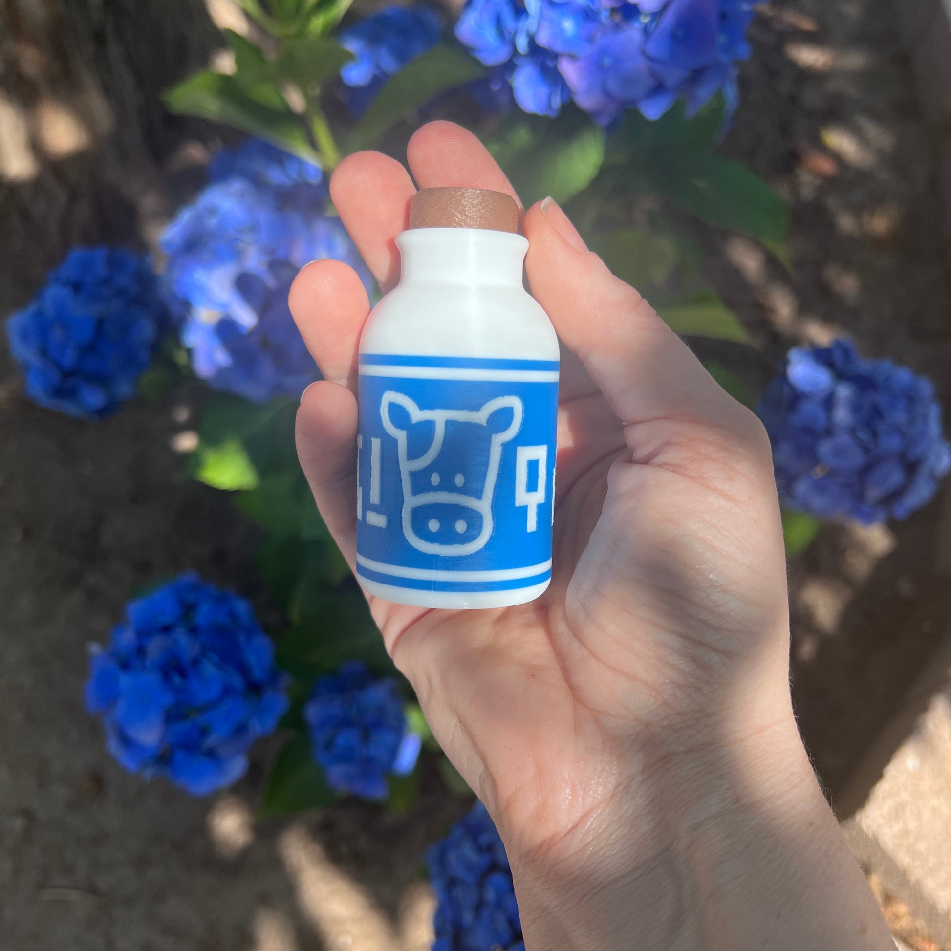 A cute Lon Lon Milk Bottle clicker toy inspired by classic games. 3D printed and handheld, great for fidgeting, gifting, or gamer-themed keychains.
