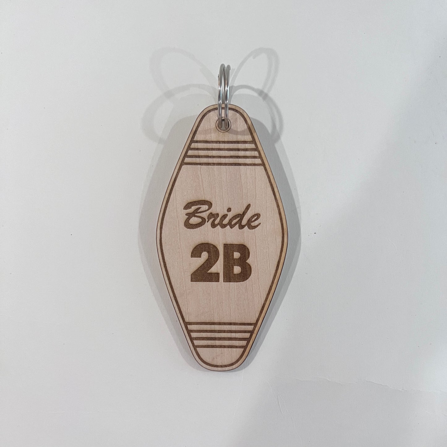 Laser engraved wooden motel keychain with “Bride 2B” design. A cute and retro gift for bridal showers, weddings, or bachelorette parties.