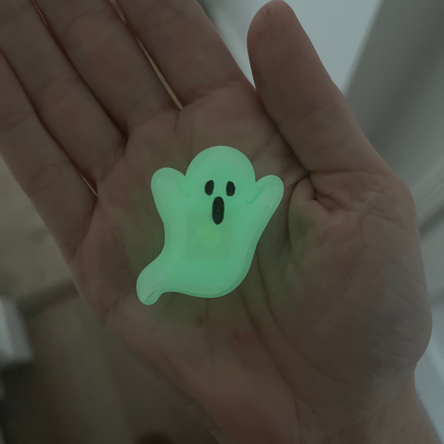 Cute Halloween clicker set with glow-in-the-dark ghost, candy corn, chocolate bat, and wrapped candy fidget toys in a festive pumpkin pail container.