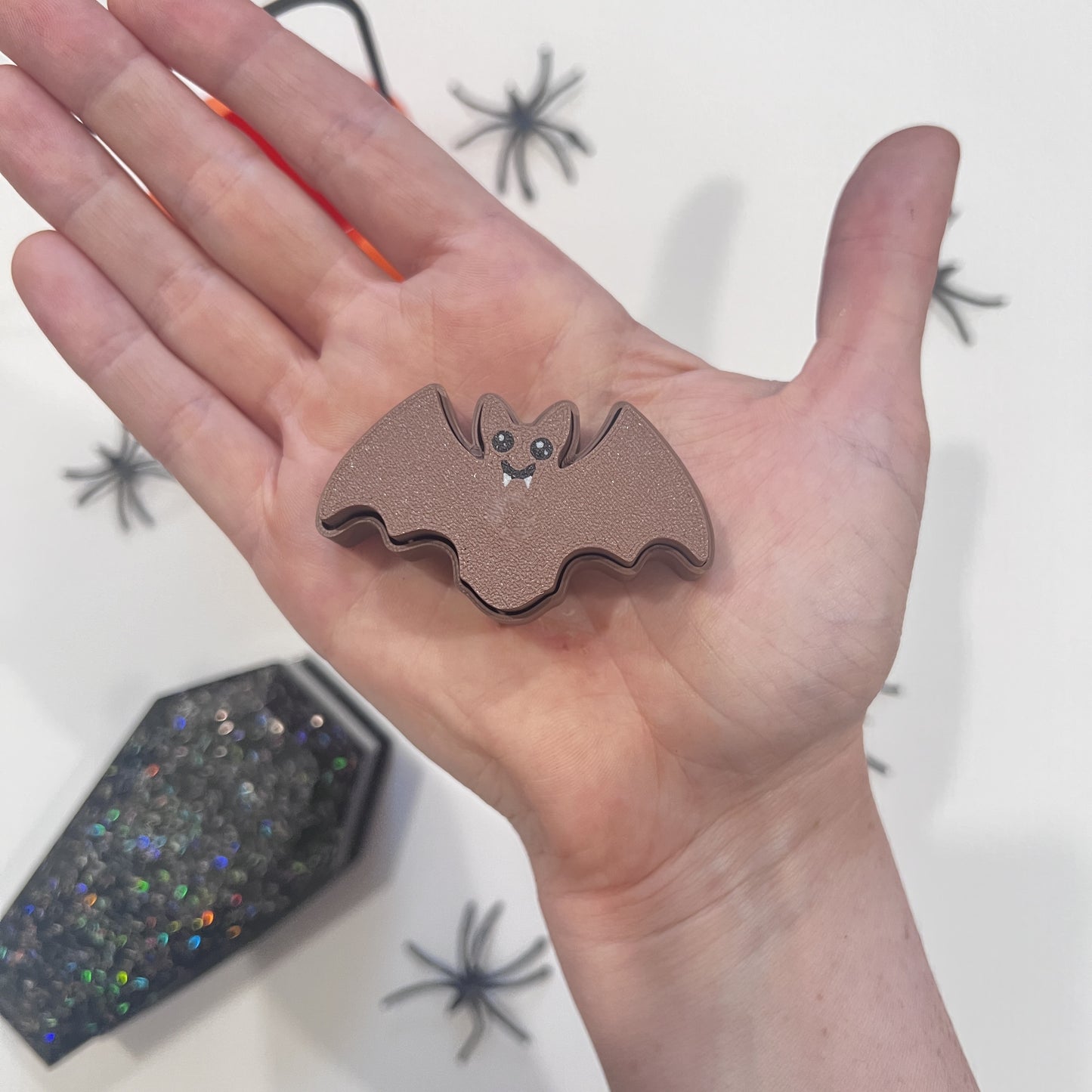 Cute Halloween clicker set with glow-in-the-dark ghost, candy corn, chocolate bat, and wrapped candy fidget toys in a festive pumpkin pail container.