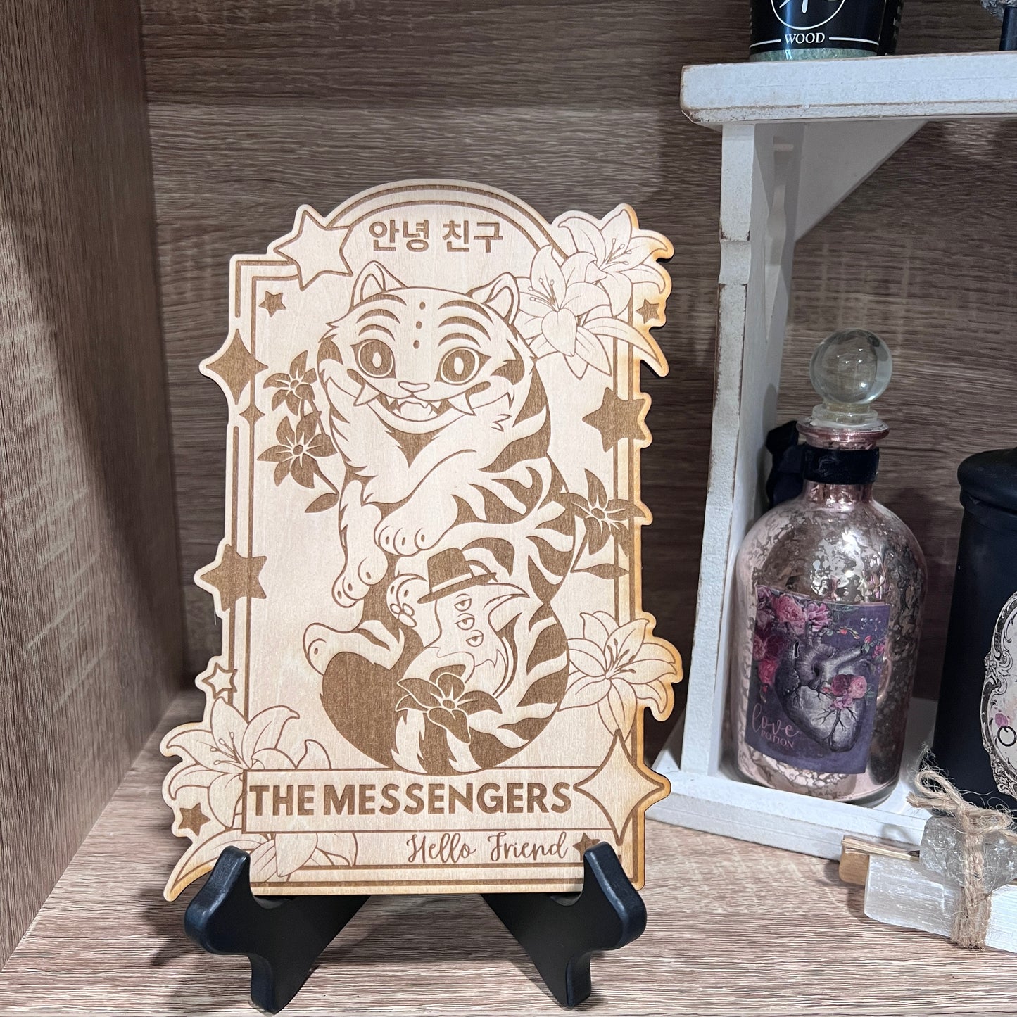 Wooden tarot card engraved with Derpy Tiger as The Messengers from KPOP Demon Hunters. Whimsical design with a magical, mystical twist.